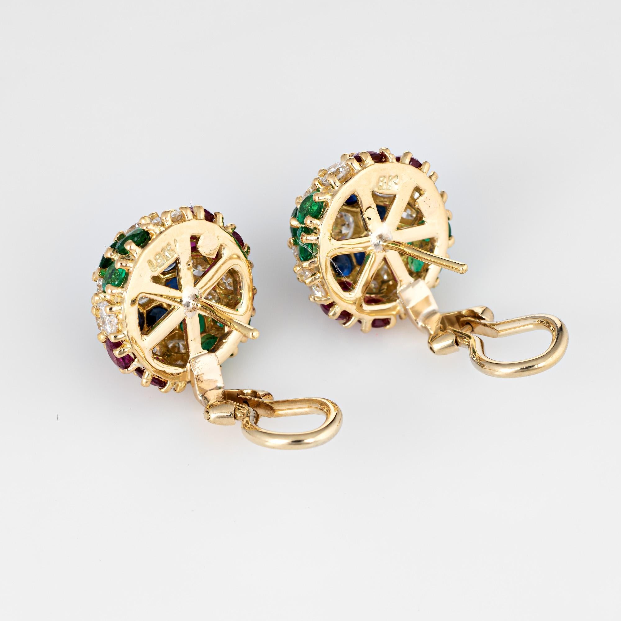 Elegant pair of gemstone cluster earrings crafted in 18k yellow gold. 

Round brilliant cut diamonds total an estimated 2.70 carats (estimated at G-H color and VS1-2 clarity). Emeralds, sapphires and rubies each total an estimated 0.72 carats
