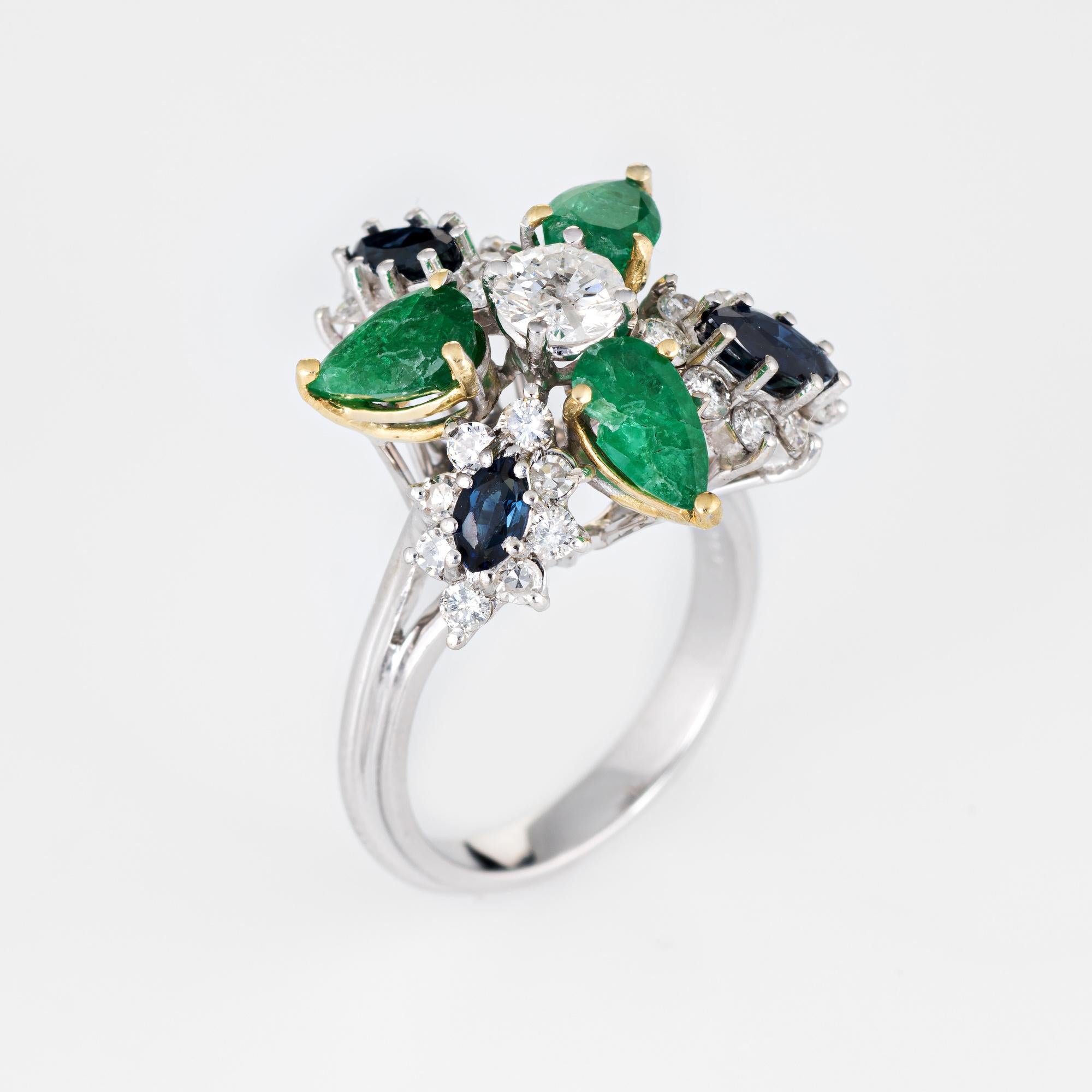 Stylish vintage gemstone cluster ring (circa 1960s to 1970s), crafted in 18 karat white gold. 

Centrally mounted estimated 0.45 carat round brilliant cut diamond is flanked with a further 24 estimated 0.03 carat diamonds. The total diamond weight