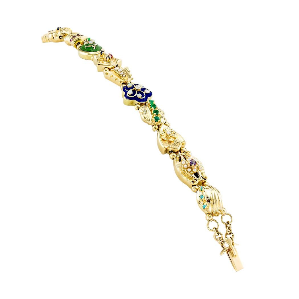Gemstone diamond and yellow gold slide bracelet circa 1980. *

SPECIFICATIONS:

SLIDES:  eleven unique slides decorated with enamel, diamonds, pearls, and various types of precious gemstones.

DIAMONDS:  two round brilliant-cut diamonds totaling