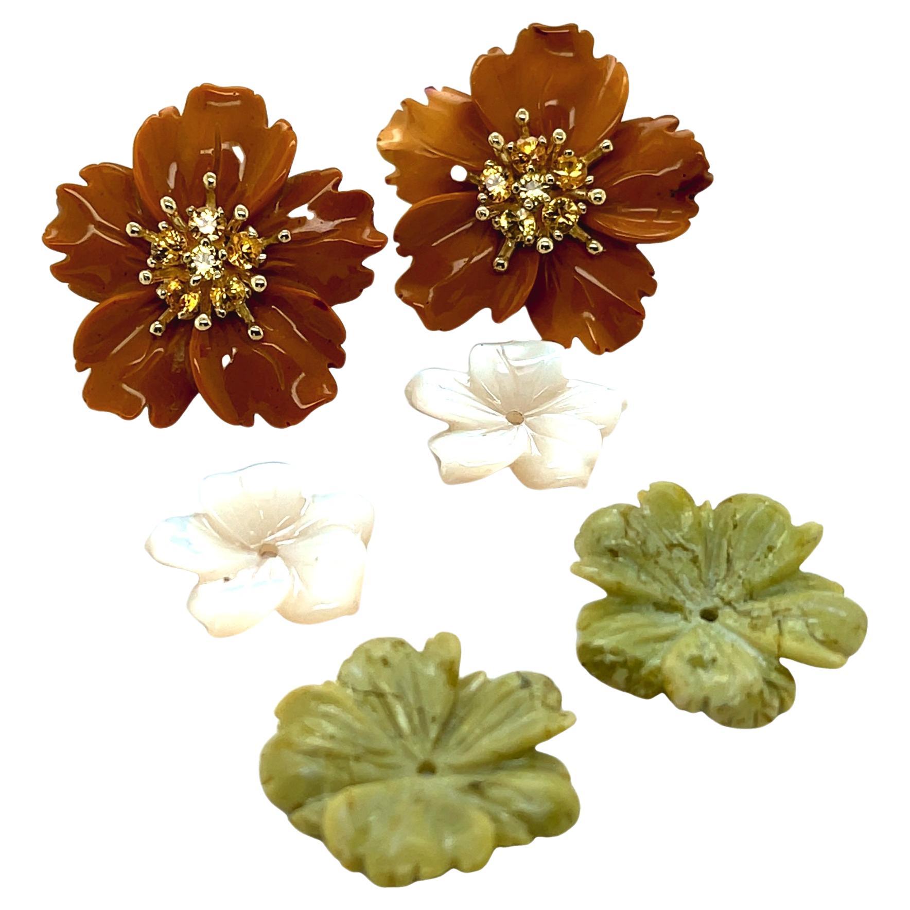 Golden and green jasper and mother-of-pearl are hand carved into flower shapes that can be worn with any post earrings. Our set of flowers features a pair of 18k yellow gold 
