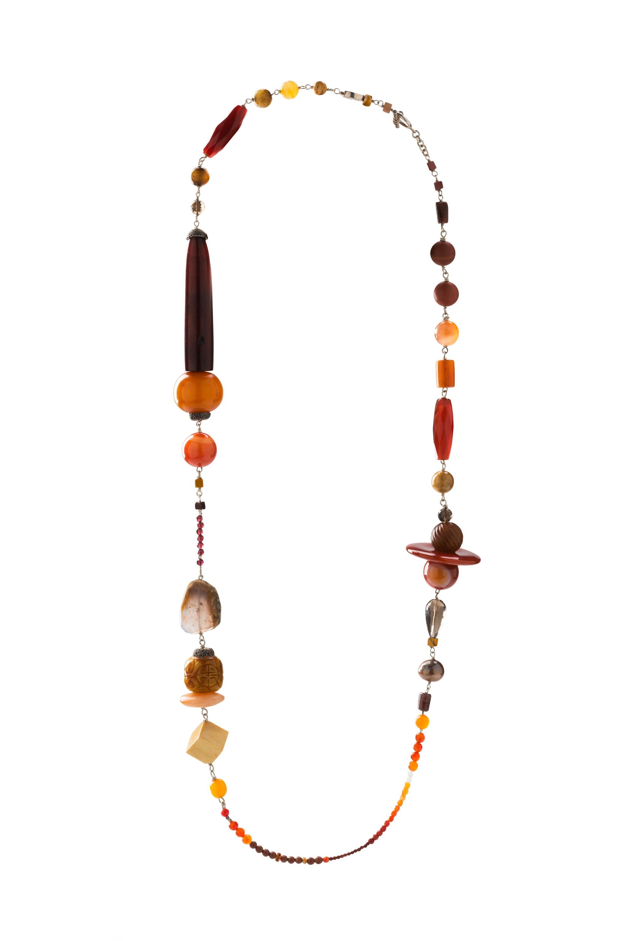 International award-winning Jewelry Design and Academic Dr. Jane Magon's created this necklace called SETTING SUN ON ULARU with the main stones being Carnelian, Agate, Mexican Fire opal. The inspiration is the Setting Sun on Ularu refers to Jane's