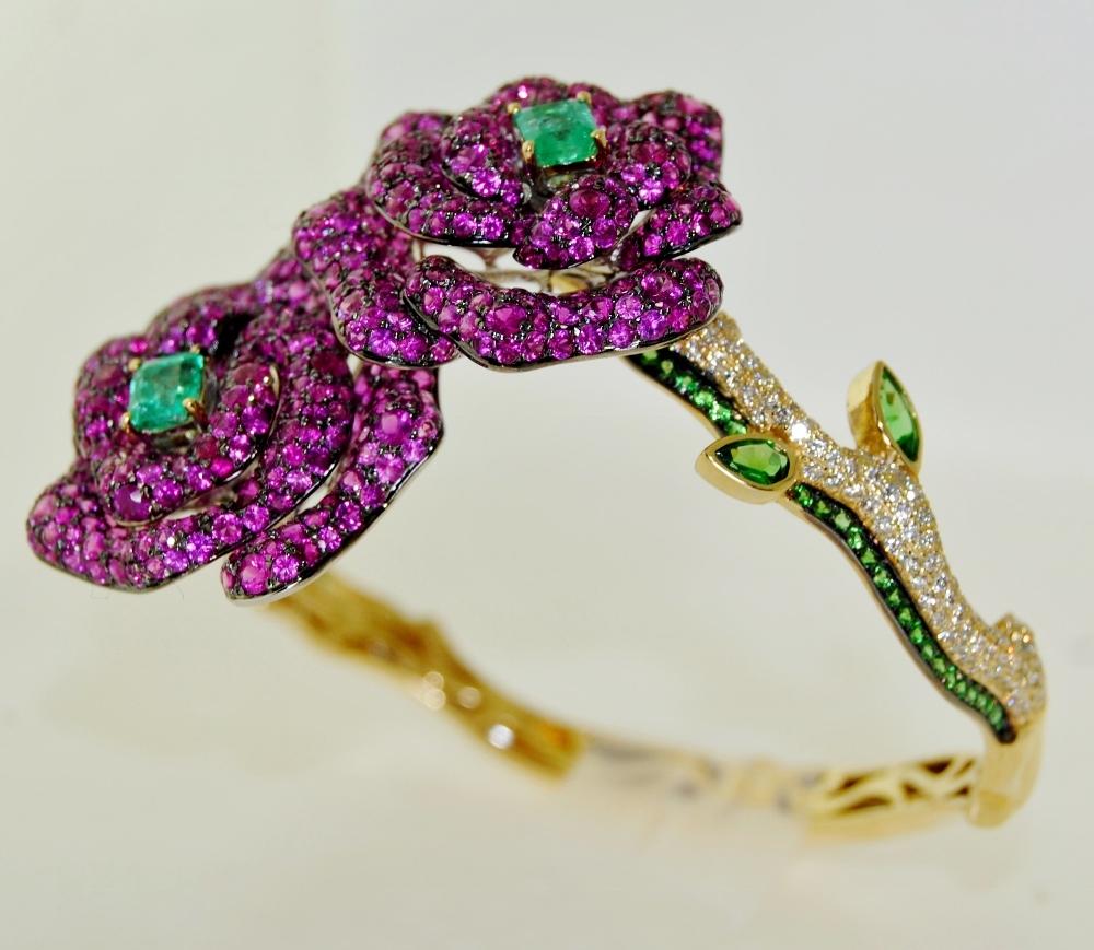 Ladies Gemstones Bangle with 2 Emeralds 1.17 carat, Sapphires & Ruby weighing 14.00 carat and 1.83 carat of Brilliant White Diamonds.  This bangle is made of 18 Karat Yellow Gold, Size 7. 