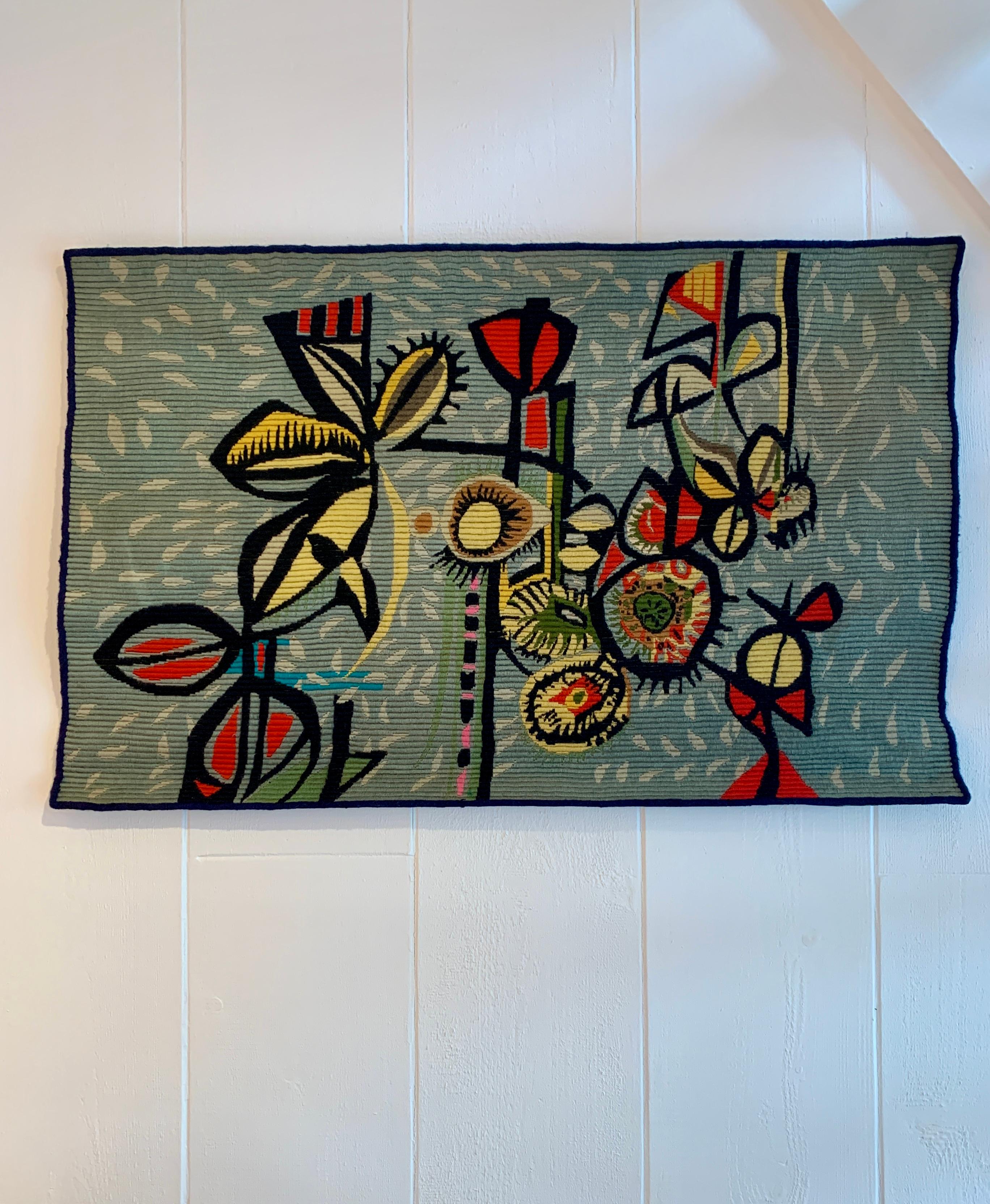 With a dimension of 114 x 74 cm, this tapestry in small point technique presents a drawing evoking an imaginary garden and a dreamlike tropicalism composed in an abstract way. On a blue background, the shapes are woven in a balance of pastel tones