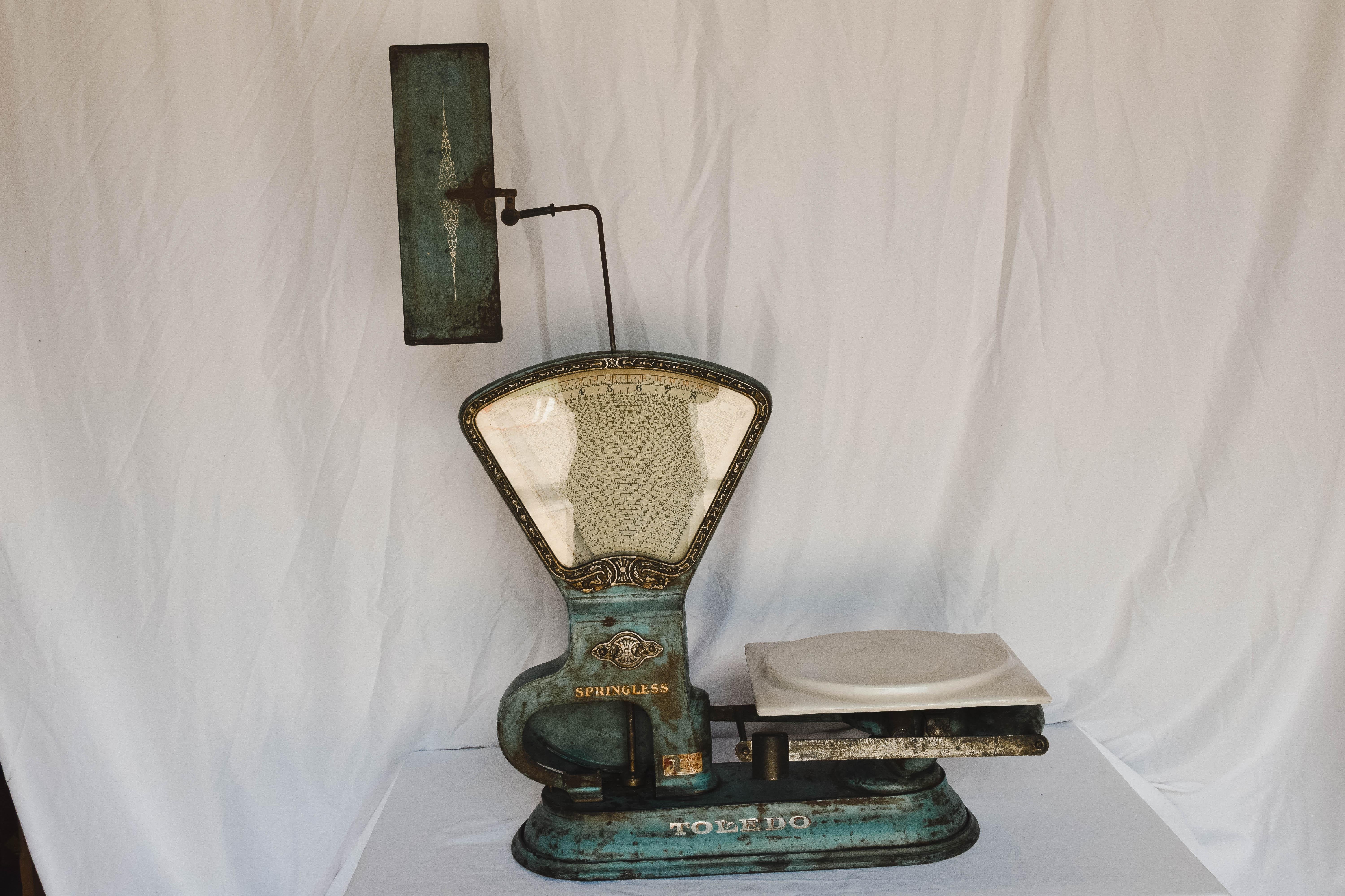 This antique Toledo springless computing store scale is a wonderful display piece. With its aged original robin egg blue patina it has beautiful nickel and brass details.