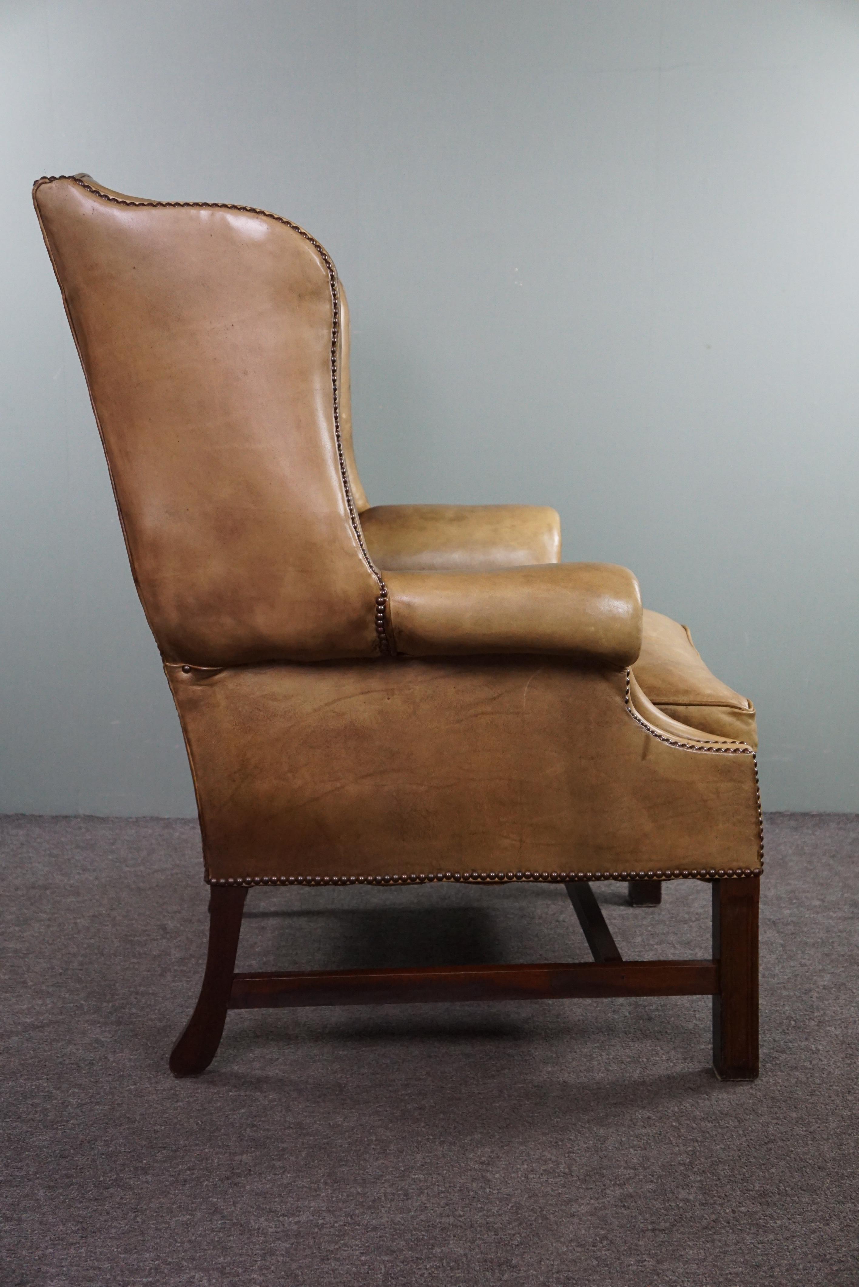 Generous leather wingback armchair in very good condition.  In Good Condition For Sale In Harderwijk, NL