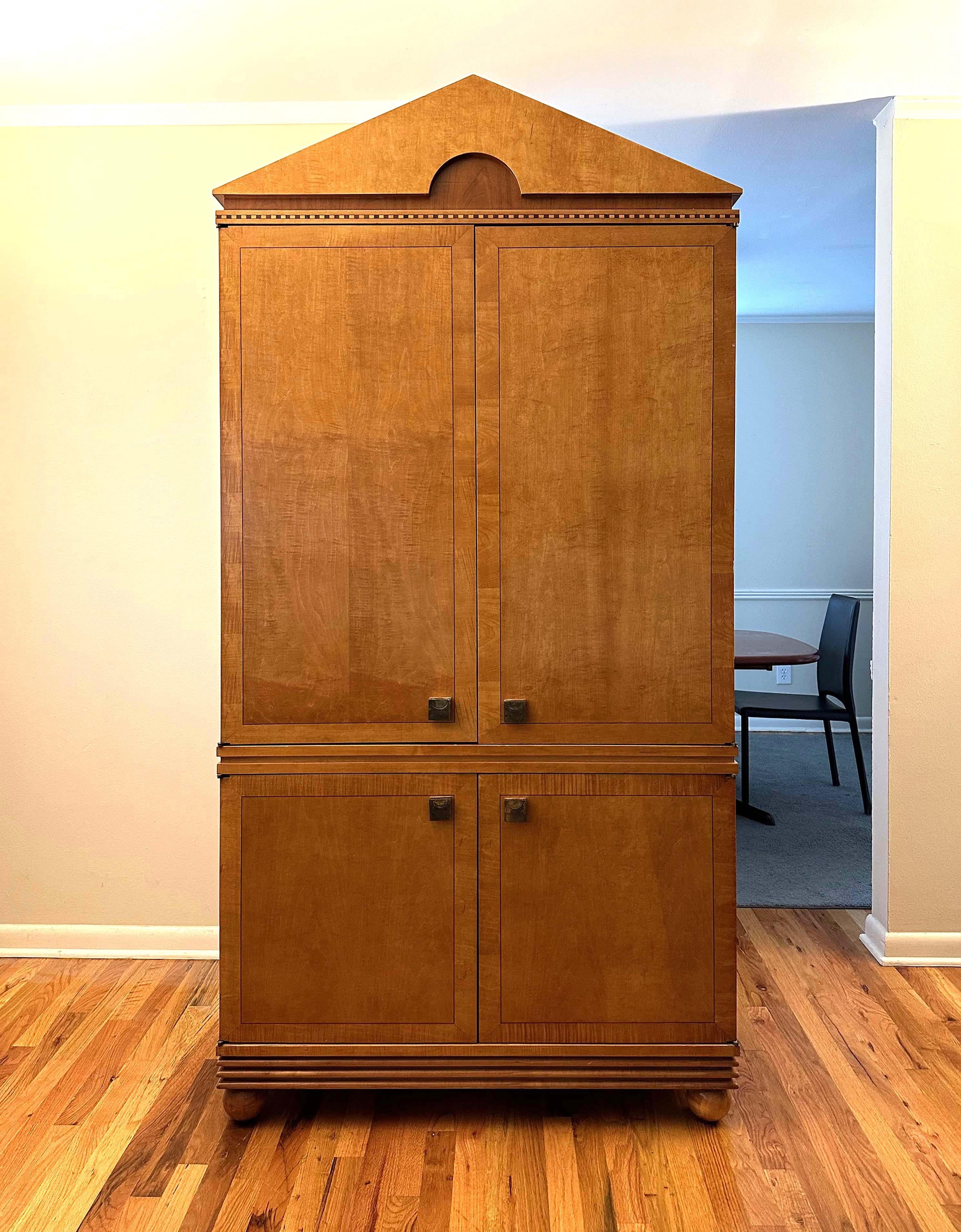 Post-modern Genesis Collection armoire in satinwood with inlaid wood detail by Hickory White. Manufactured in Hickory, North Carolina, 1993.

1 stationary and 2 adjustable shelves in the upper cabinet. 3 drawers in the lower cabinet. Hammered brass