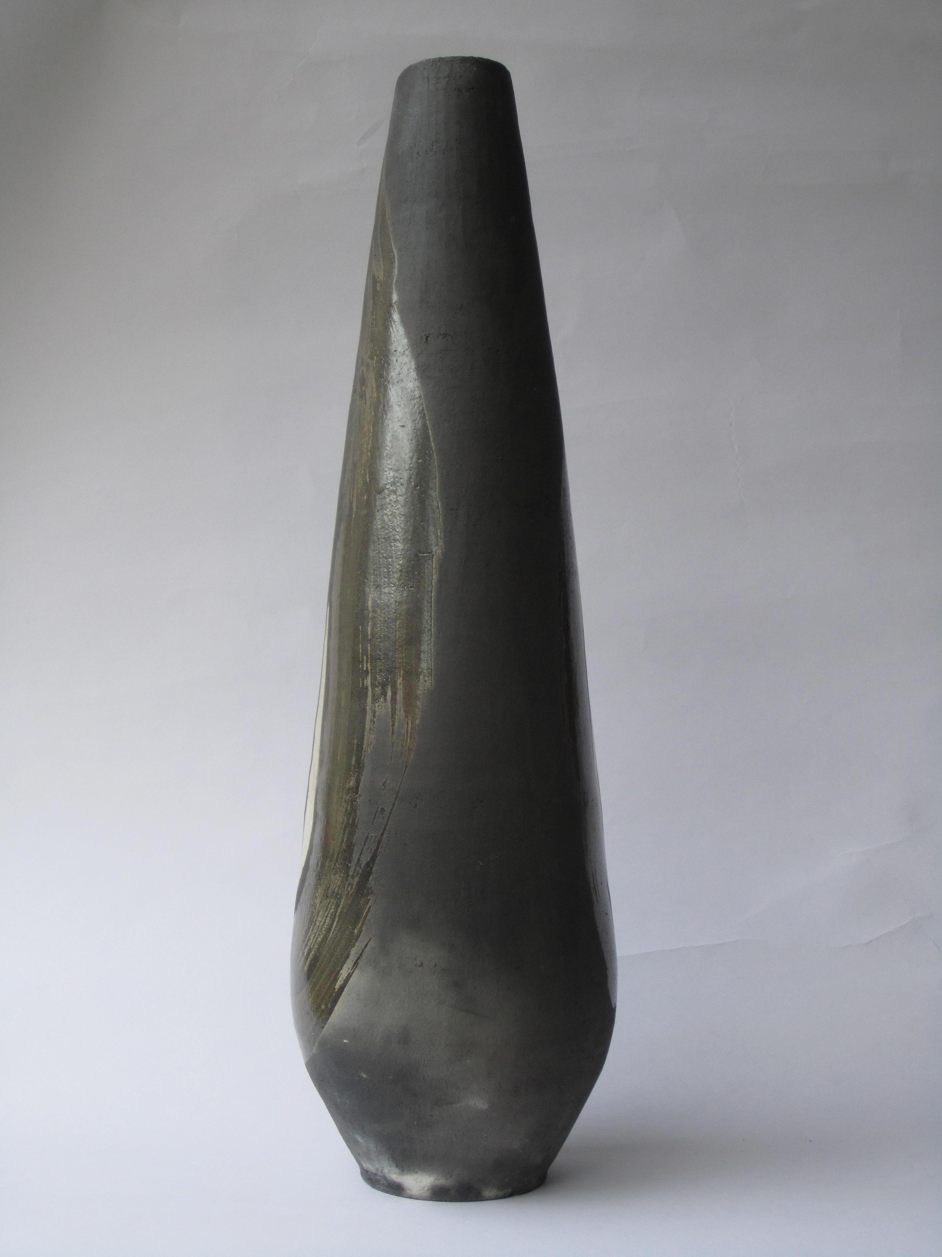Genesis III is a raku fired handmade decorative high vase by artist Tien Wen.
The artist's work revolves around the idea of abstraction and the pureness of shapes. Thanks to the raku technique, the sculptures of this series (which represents the