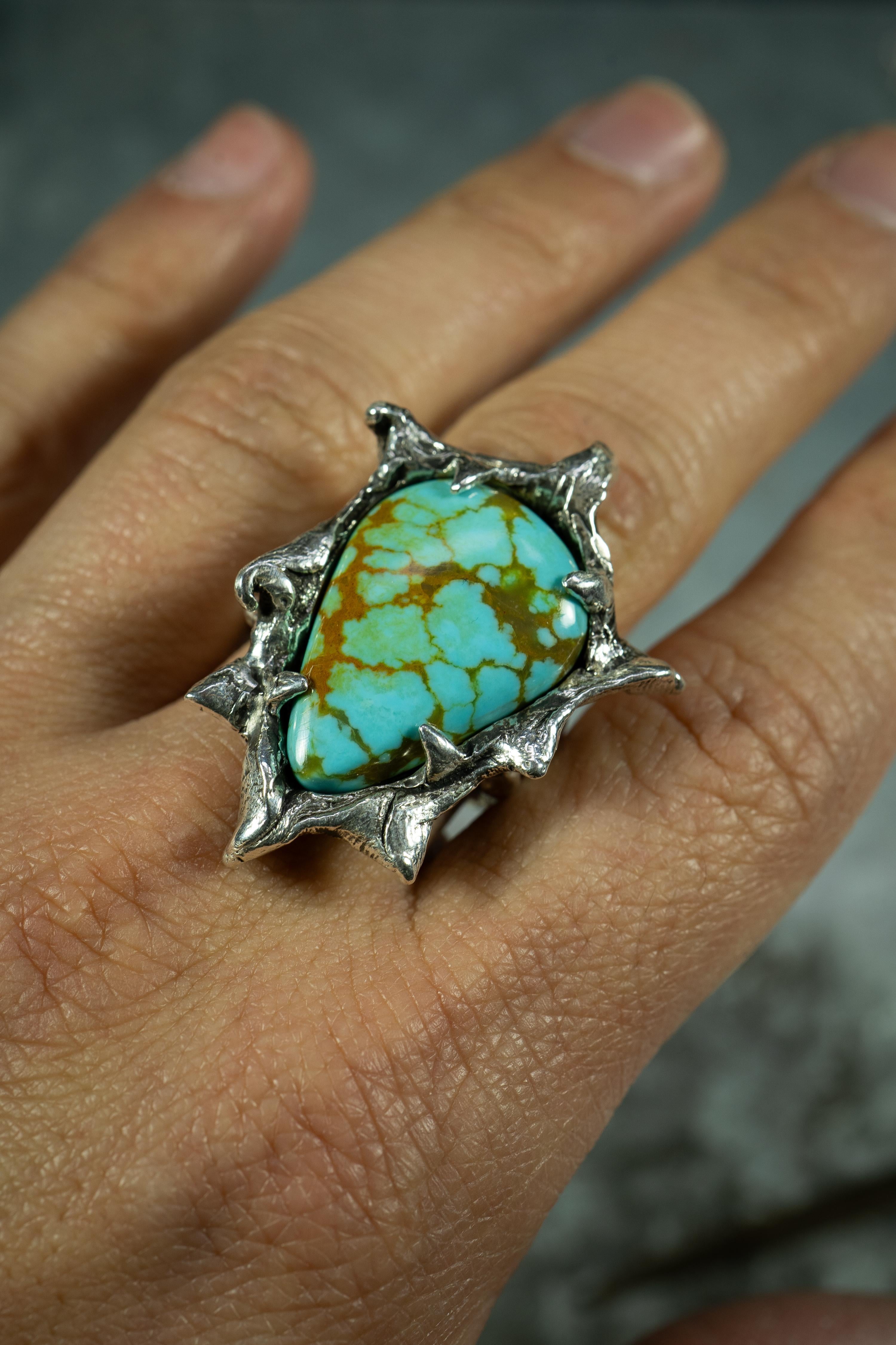 Genesis is a one-of-a-kind ring by Ken Fury that is hand-carved, cast in sterling silver, and features a Tyrone turquoise stone from New Mexico.

Ring Size: 10

Hand-signed
