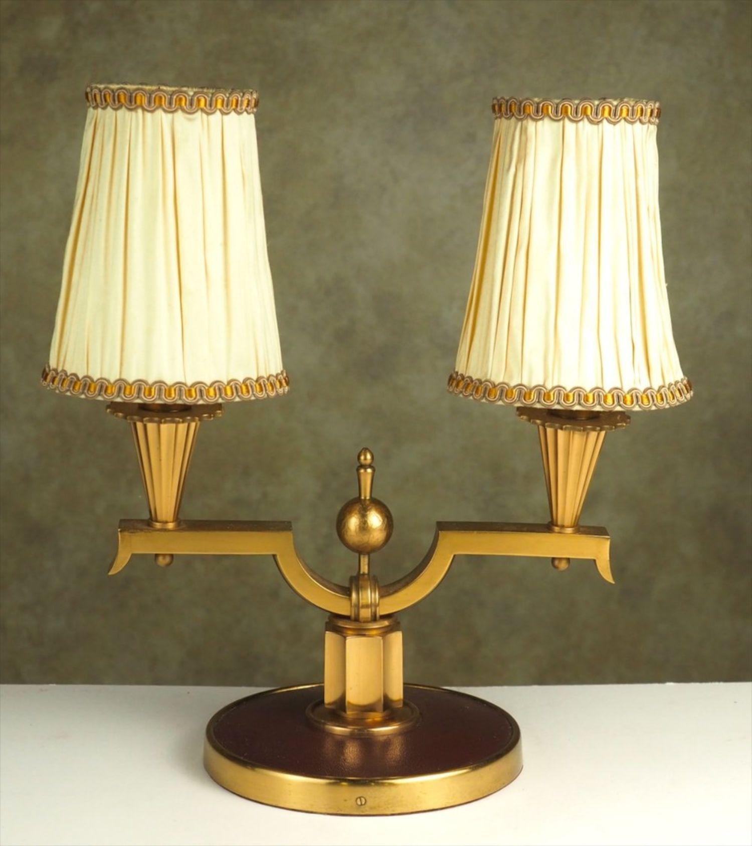 French 1940s Art Deco pair of two-branch lamps, by Genet et Michon in gilt bronze and original leather. Shades are re-covered original frames. Measures: 14