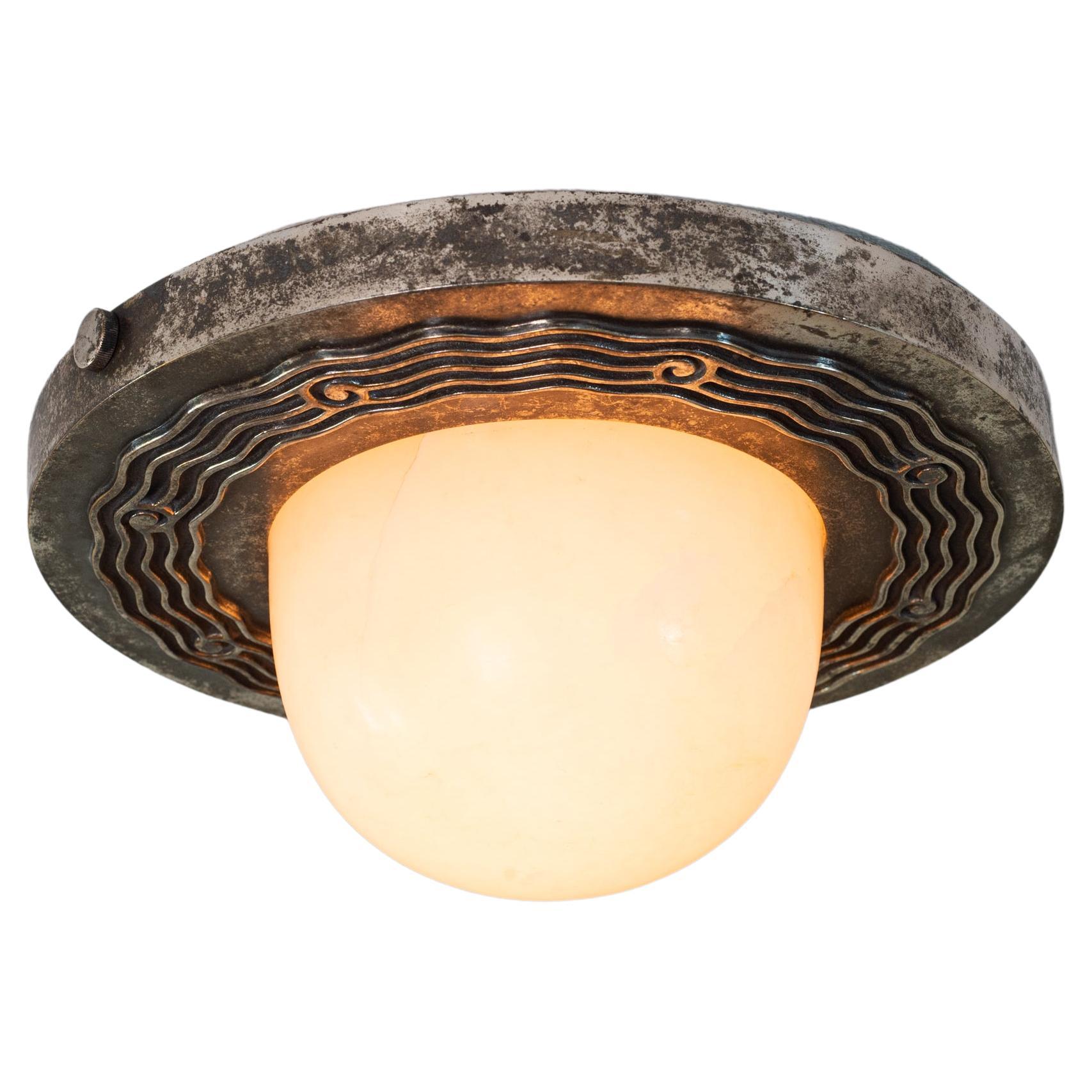 A stunning French Art Deco flush mount comprised of a silvered-bronze base that holds a carved alabaster light bowl. Some attribute this design to Emile-Jacques Ruhlmann, who collaborated with Philippe Genet and Lucien Michon.