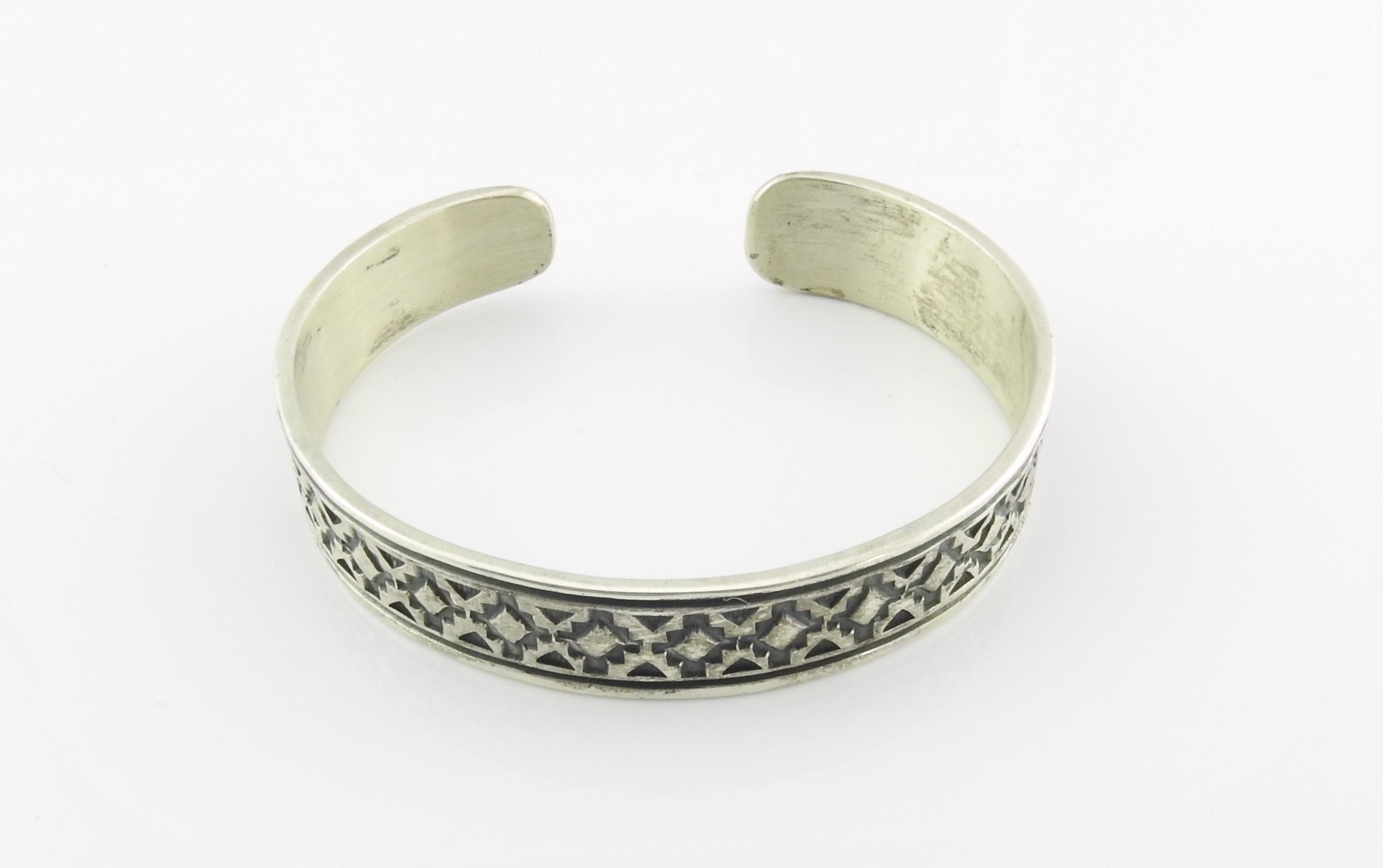 Native American Navajo gestempelt oxidiertem Sterling Silber Manschette Armband von Handwerker Geneva Ramone.

Gezeichnet: STERLING.

Unterschrieben: G. Ramone.

Maße: 6 3/8