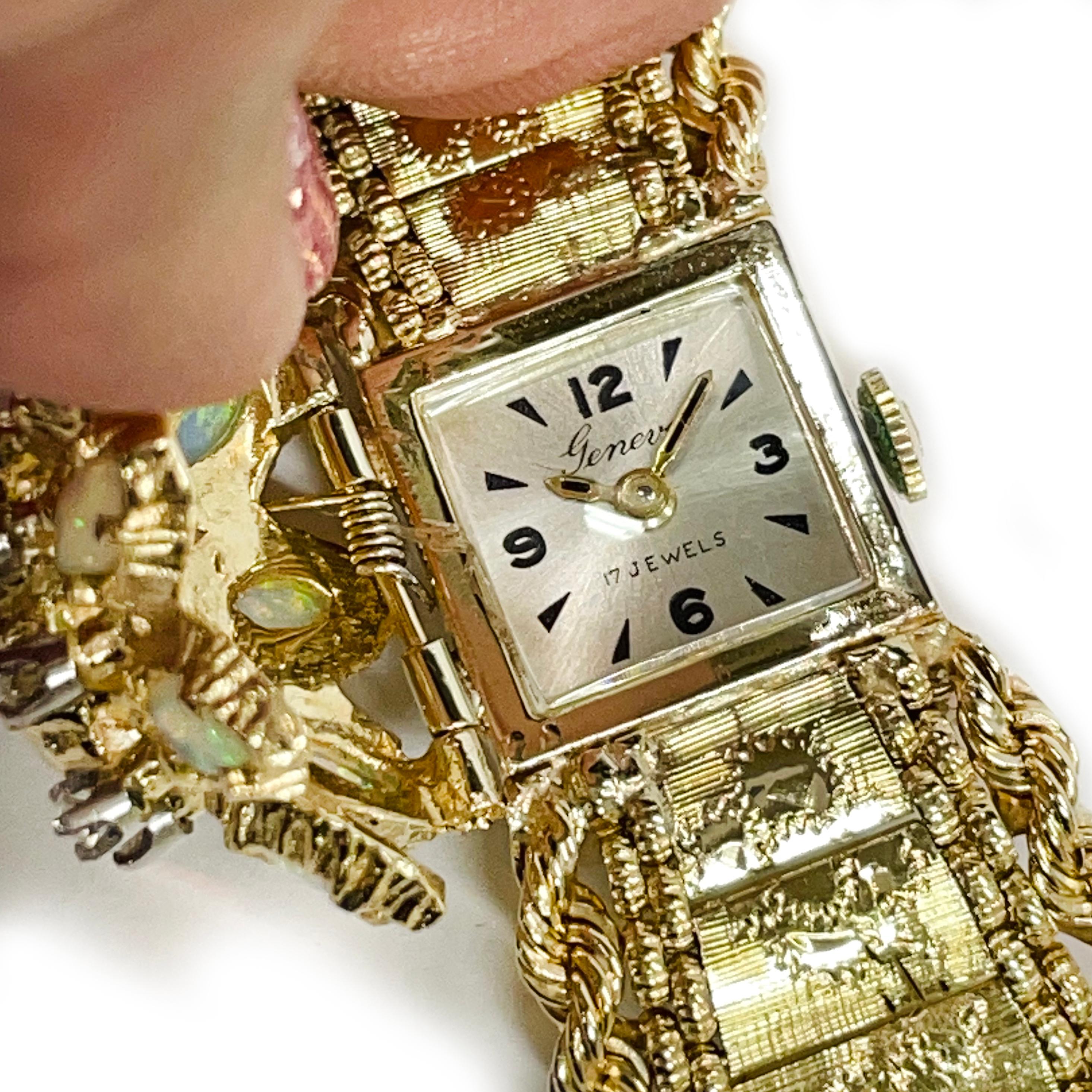 Geneva 14 Karat Yellow Gold 17 Jewels Opal Diamond Wristwatch. This exquisite watch features a hinged top with marquise opal stones and round diamonds. There are eight marquise measuring 5.5 x 3.0mm and one marquise opal at the center measuring 8.0