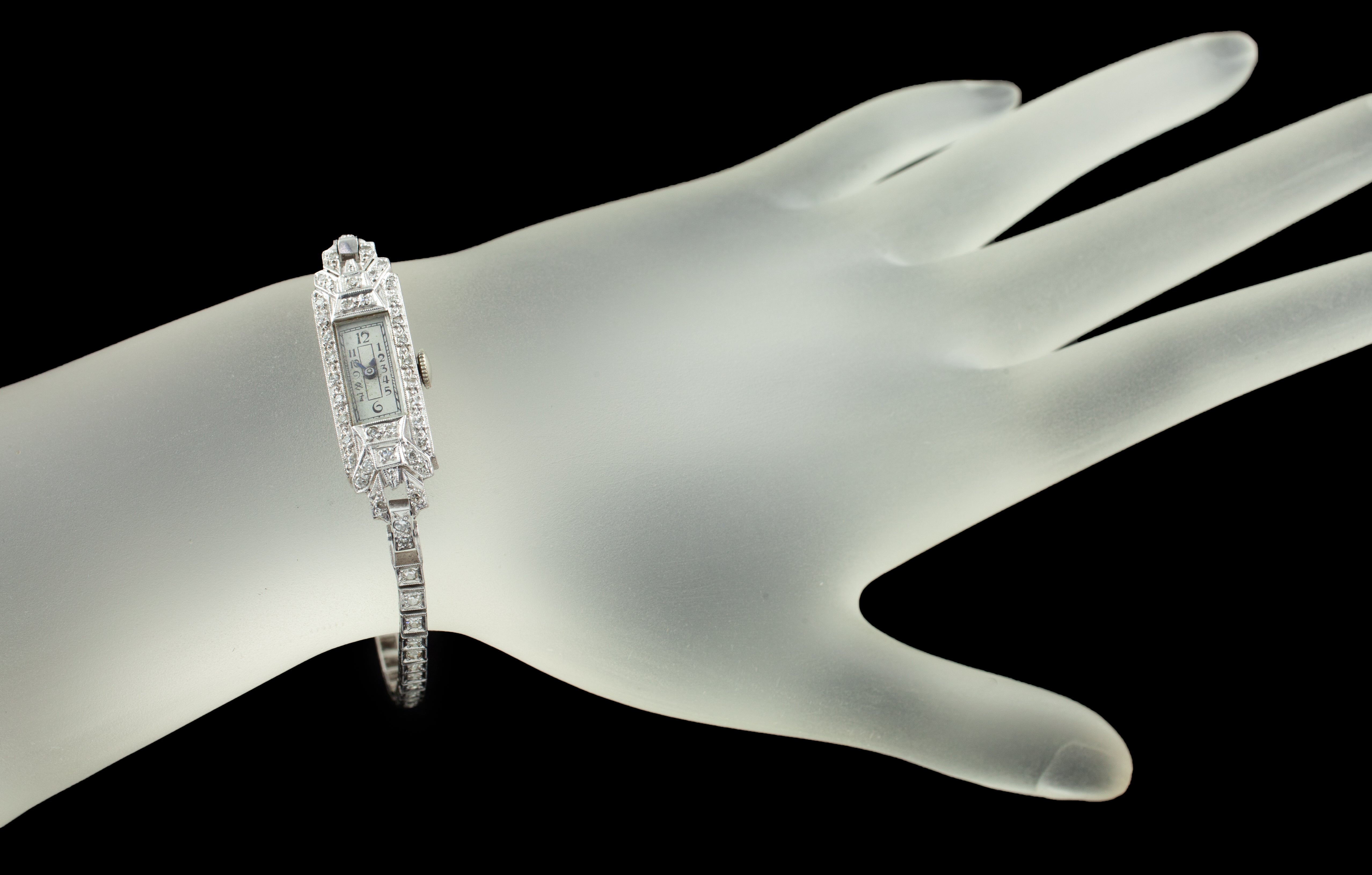 Geneve Platinum Diamond Women's Hand-Winding Watch w/ Milgrain Detailing

Movement #MWMANN
Calibre #FHF59

Platinum Art Deco Rectangular Case w/ Diamond Accents
28 mm Long
10 mm Wide (12 mm w/ Crown)
Lug-to-Lug Width = 2 mm
Lug-to-Lug Distance = 34
