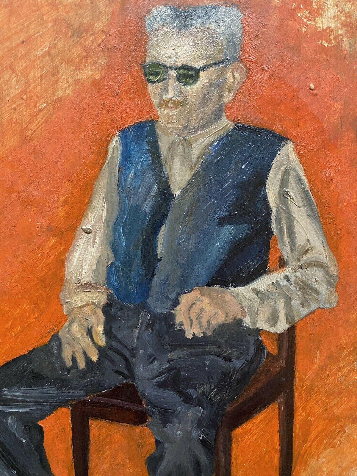man in chair painting