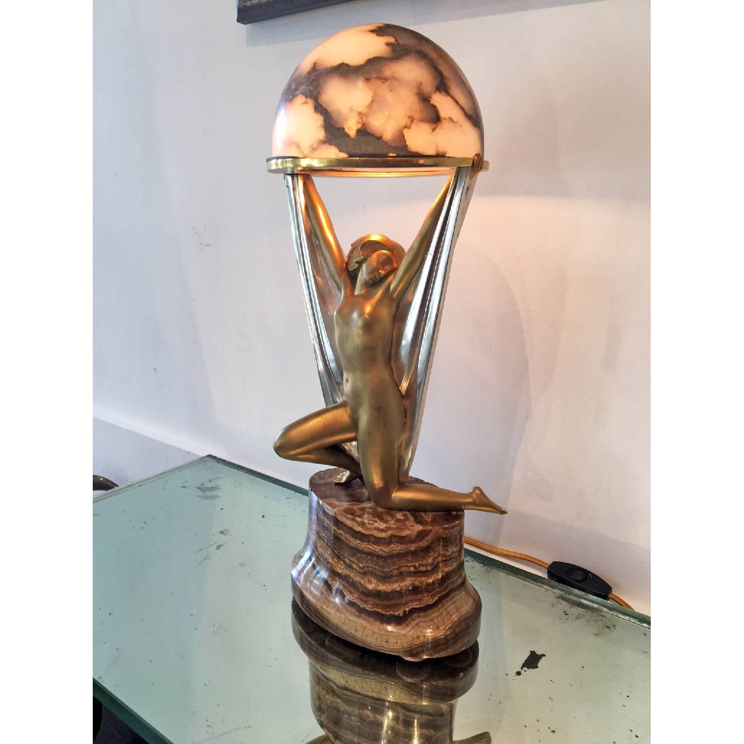 Authentic Art Deco sculptural lamp entitled: Genie & The Lamp designed by Alexander Kelety, it depicts a female figure holding an alabaster globe that illuminates.
Made in France,
circa 1930.
Signature: A. kelety.