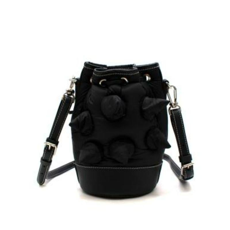 Moncler Genius JW Anderson black nylon & leather The Critter bucket bag
 
 - Collaborative design as part of the ongoing Genius series]
 - Bucket shape rendered in black nylon with 3-D spikes, and leather top and strap
 -Adjustable, removable