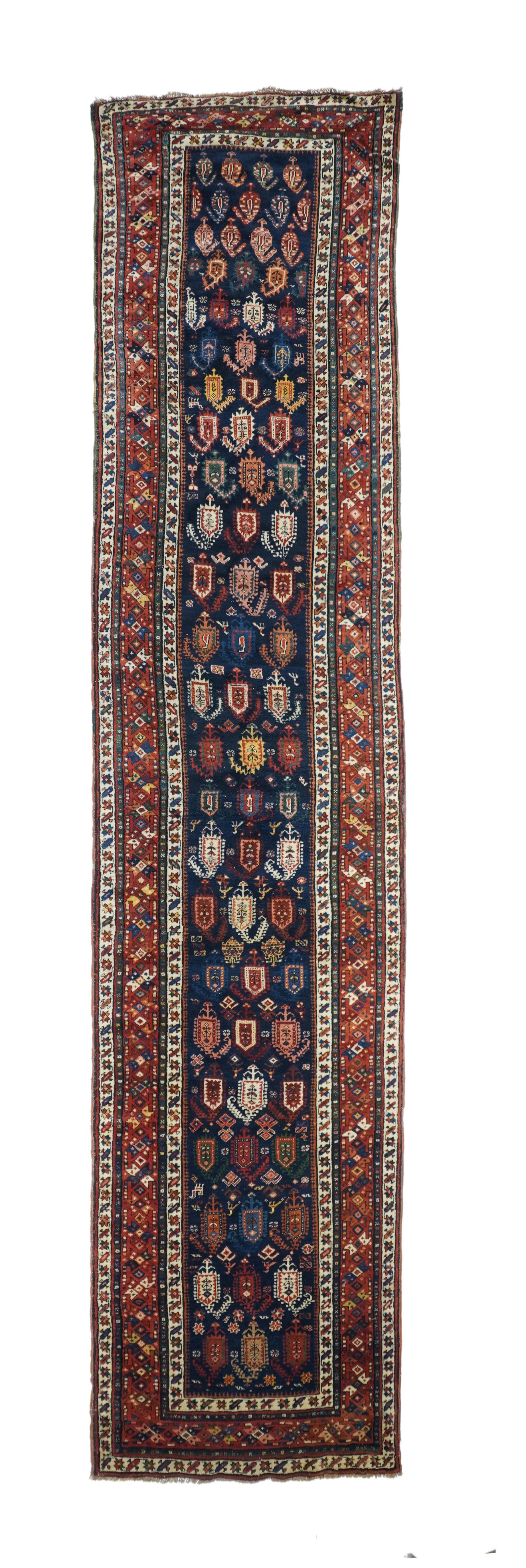 Antique Genje Runner 3'2'' x 14'1''. Not a Caucasian Gendje, but something from a village south of the bordering Arax river. The camel-tone field is zig-zagged or stepped on its edge, fitted within triangular red corner, and displays a central