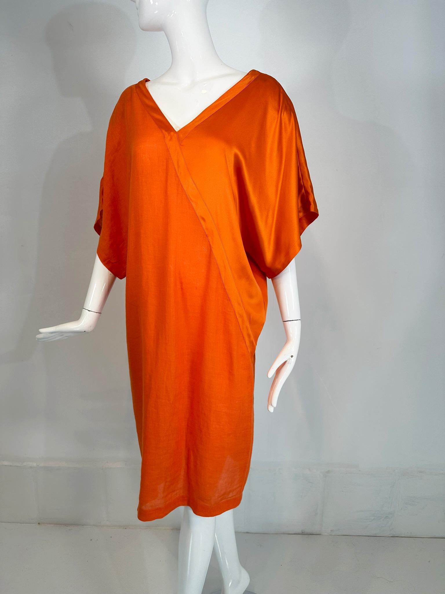 Genny 1990s mandarin orange linen & silk kimono sleeve sac dress. Gorgeous shade of orange in a lightweight dress that is part linen & part silk each separated with a diagonal band front & back. Loose fitting dress has wide drape kimono sleeves and