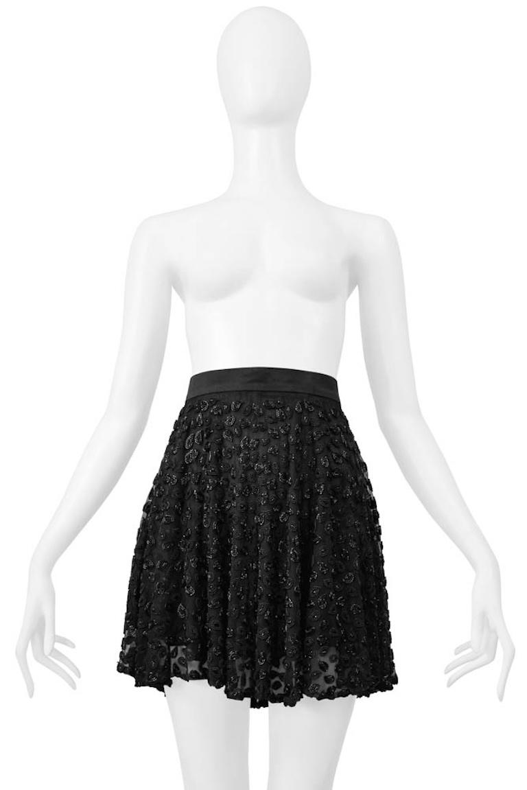 Resurrection Vintage is excited to offer a vintage Genny black chiffon mini skirt featuring heavily beaded paisleys, a satin waistband, a single button closure with a center back zipper, a gathered multilayer circular skirt, and a flirty, slightly