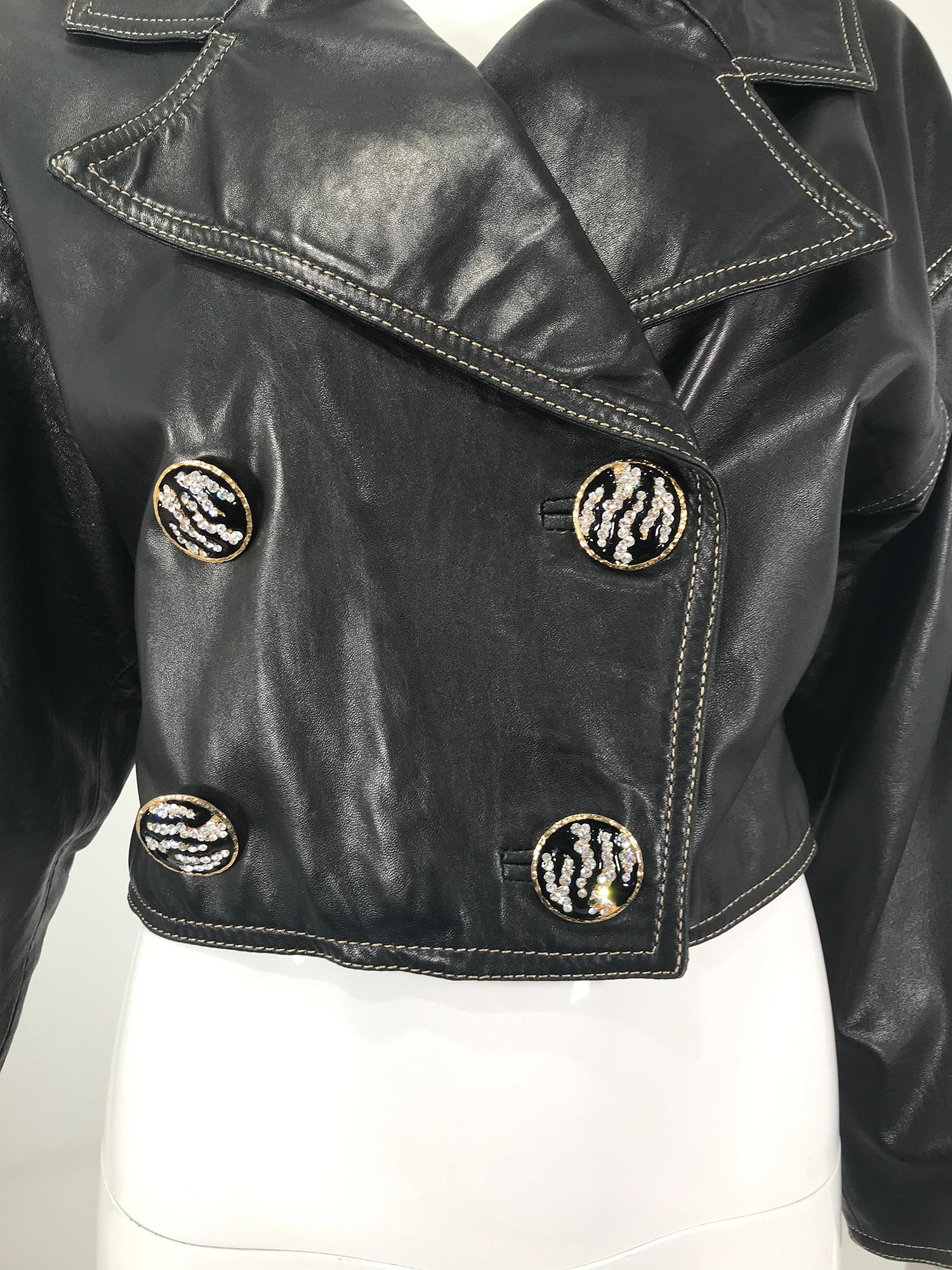 Genny buttery soft black leather bomber jacket with rhinestone buttons and gold stitching, from the 1980s. Double breasted, cropped jacket with wide notched lapels, the large buttons are gold with black enamel and rhinestones. Dropped shoulder seam,
