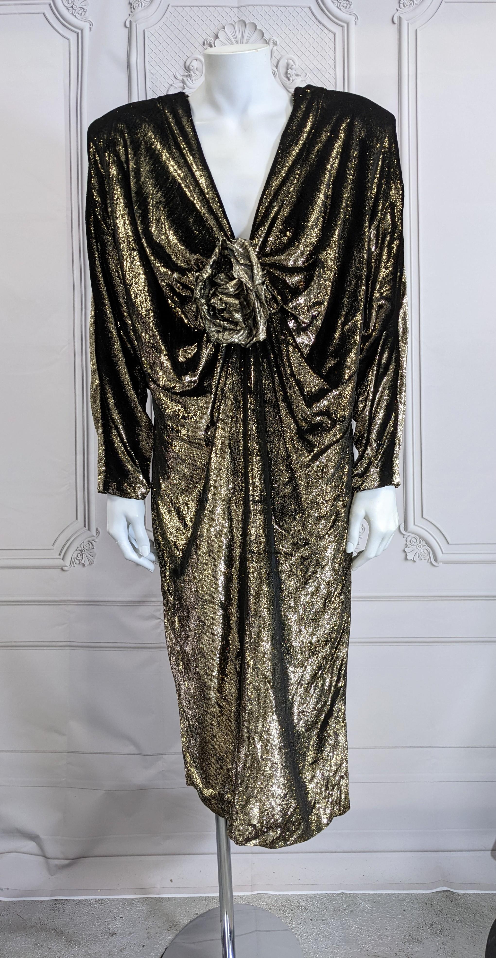 Genny by Versace Draped Lurex Velvet Cocktail Dress from the 1980's. Oversized shoulders and deep plunge accented with a gold lame textile rose. Dress pegs toward the hem from the strong shoulders (to offset period big hair) and the antique gold