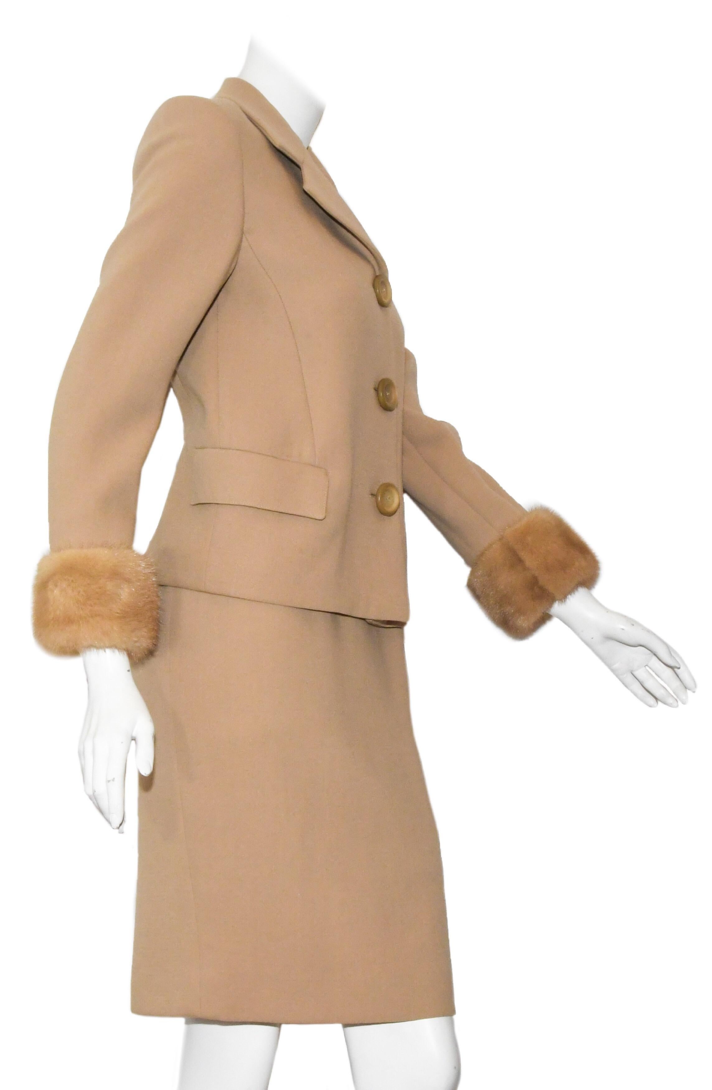 This stunning mid-weight wool suit is Genny at it's best!  This beautiful, warm beige skirt suit is perfect for any occasion.  With a classic jacket with a notched collar and two flap pockets, the whimsy of three large buttons for closure is