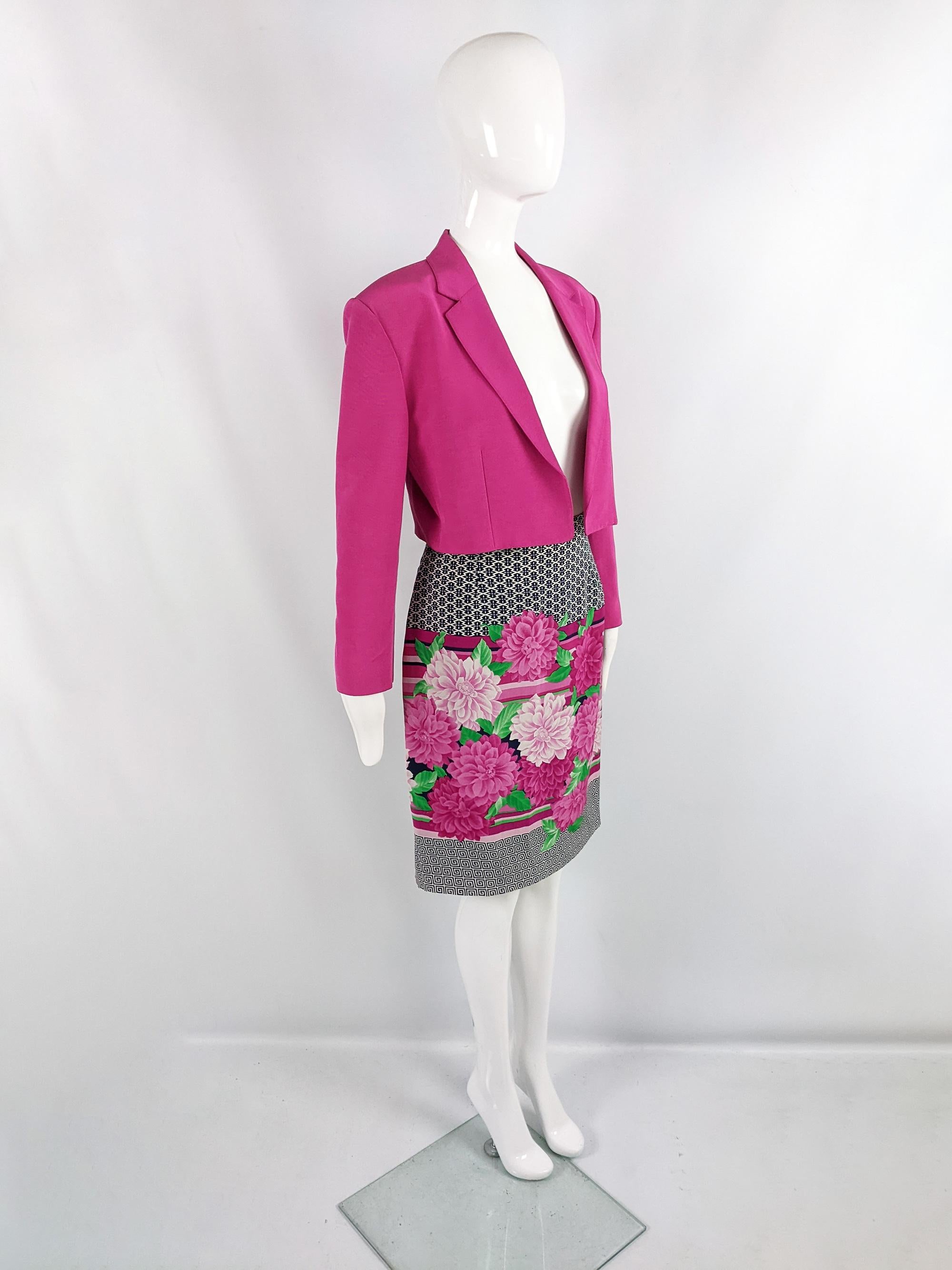 A fabulous vintage womens skirt suit from the late 80s / early 90s by luxury Italian fashion house, Genny (who Gianni Versace designed for before starting his own label). Consisting of a chic, open fronted, cropped jacket in a fuchsia faille fabric,