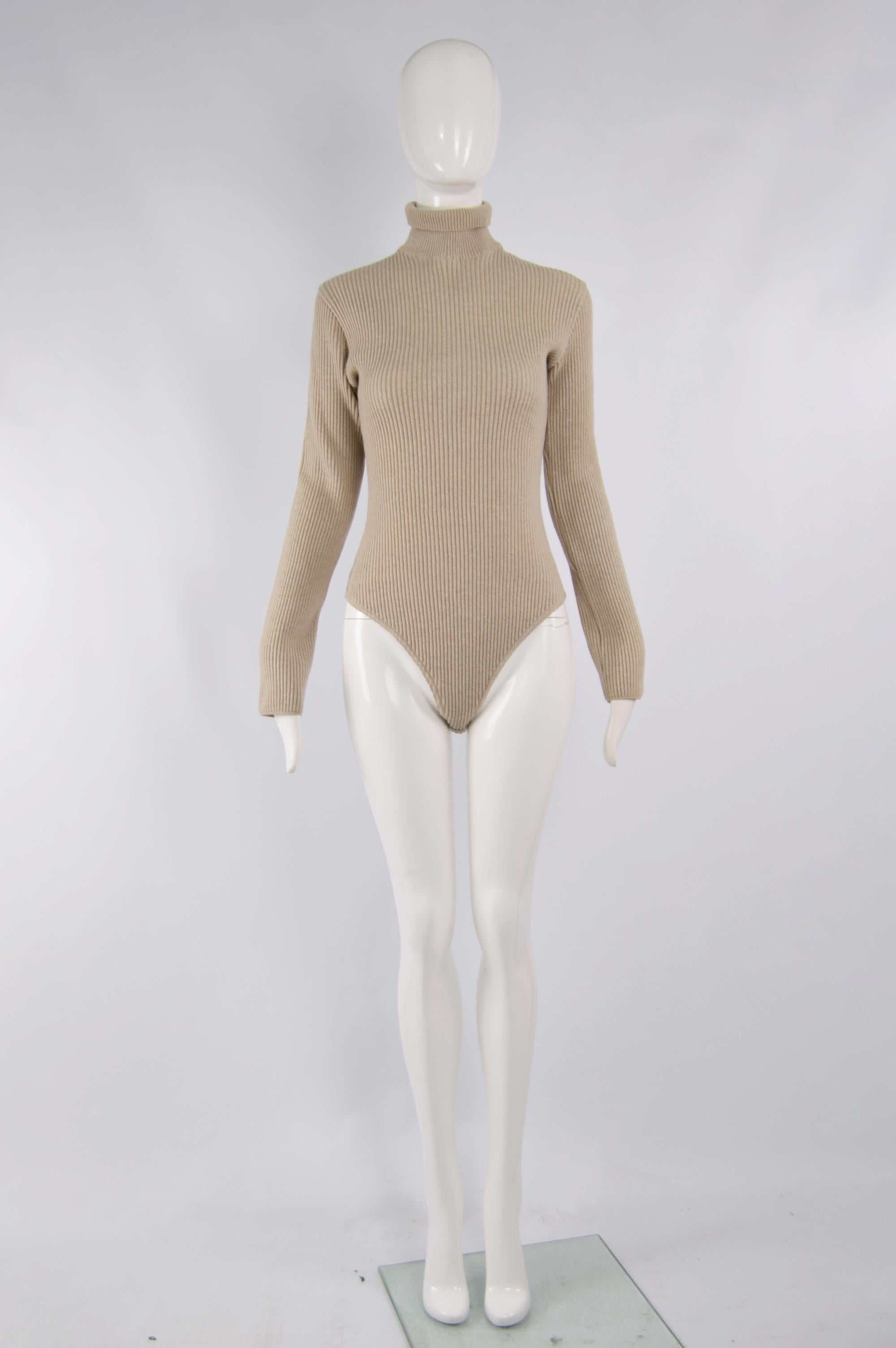 A vintage women's body suit from the 90s by luxury Italian fashion house, Genny. In a beige ribbed wool and cashmere knitted fabric with a roll / polo neck and long sleeves. 

Size: Unlabelled; fits like a Small to Medium. Please check measurements.