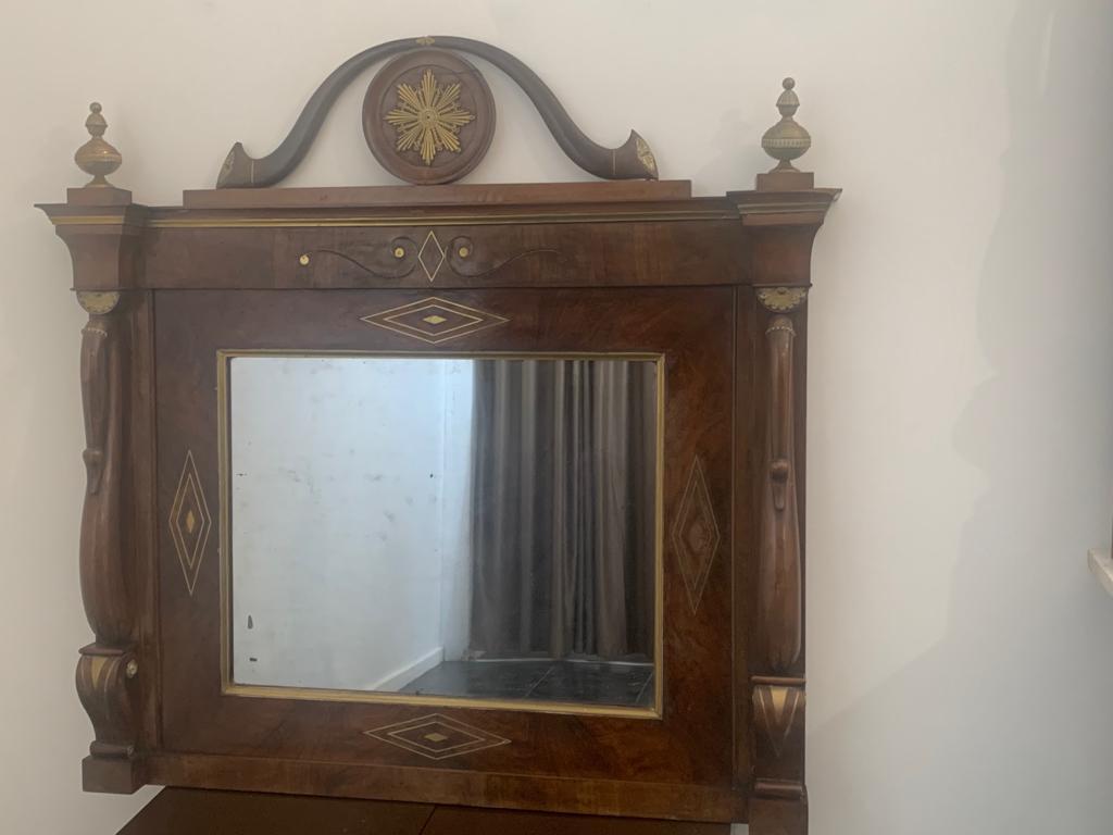 Genoese walnut mirror with brass inlays and hardware. Excellent construction, on the back it still bears eighteenth century butterfly nailing confirming the Direttorio style of the mirror. Packaged in a wooden box.