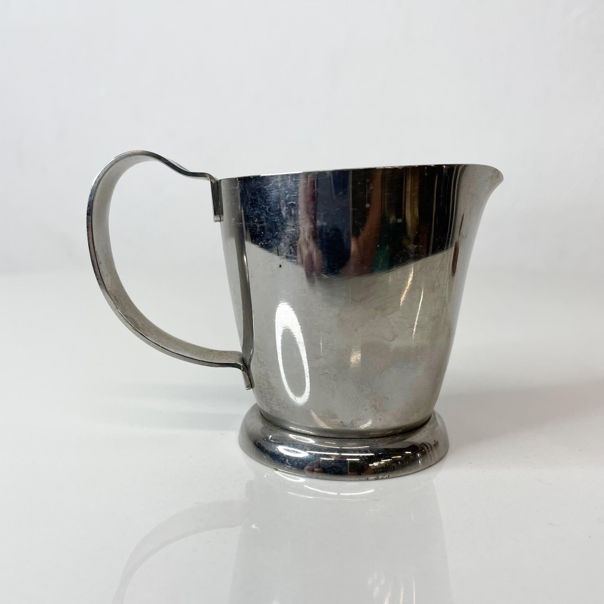 Scandinavian Modern by Gense Creamer Milk Pour in stainless steel made in Sweden
Maker stamped Gustaf Eriksson for Gense ALP
Measures: 2.5 Tall x 2.25 W x 3.5D inches
Original Preowned Vintage Condition.
Refer to images.


 