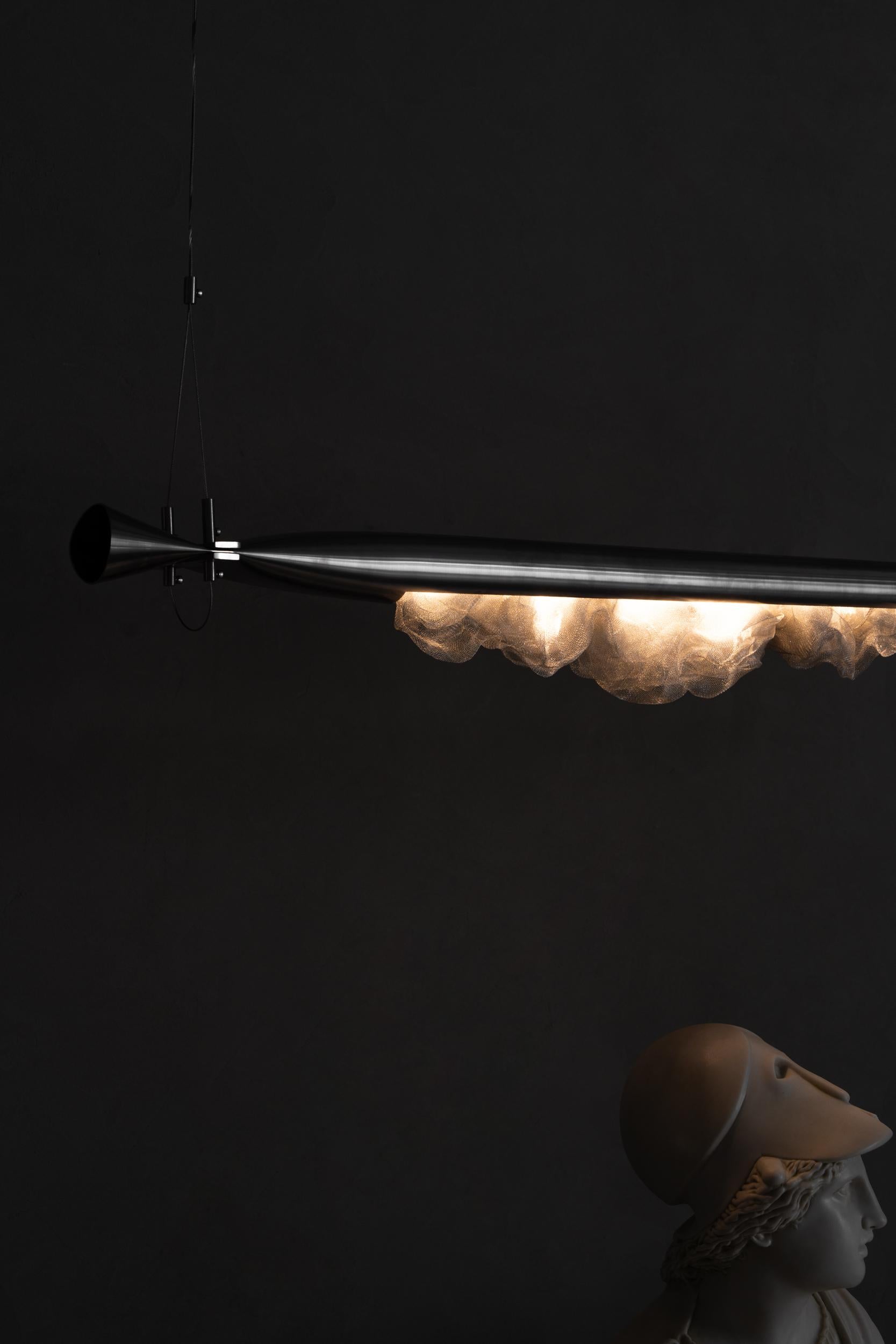 Genshi Lighting is a unique piece that combines art with modern design. Made of stainless steel, this lighting draws attention with its surface shaped by primitive movements such as crushing, bending and tearing.

Equipped with daylight LED
