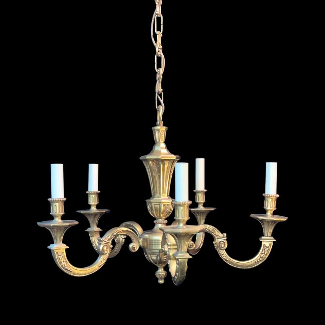 Previously hung in a gentlemen's club, this solid brass 5 arm chandelier is a stunning Classic timeless piece circa 1960s.

Weighs around 20lbs.

Width approximately 61cm.

Ornate ceiling rose & chain included.

Rewired with antique gold