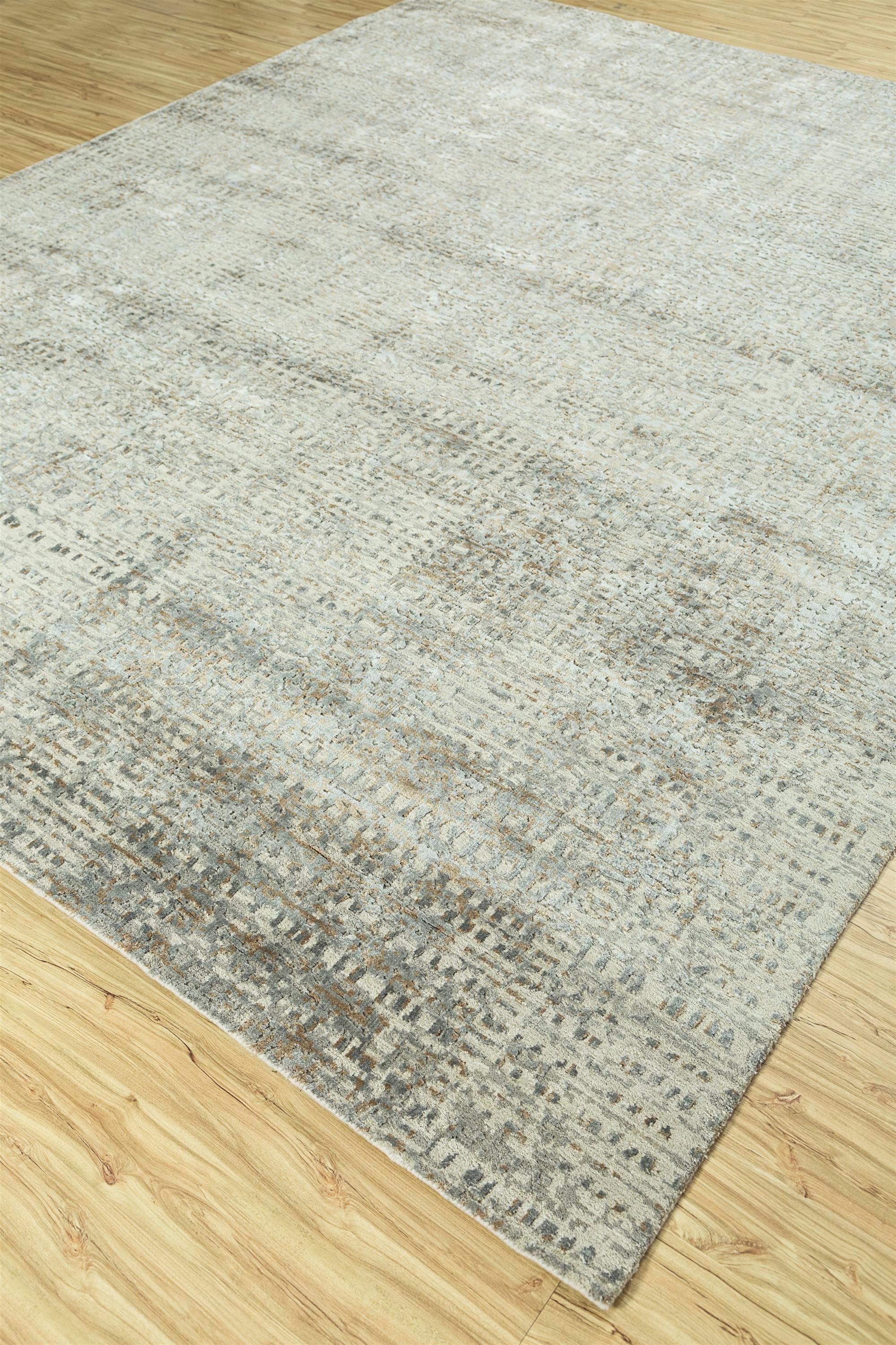 Step into modern elegance with our hand-knotted rug, harmonizing soft gray and antique white in a contemporary masterpiece. It blends mesh textures and creates a serene atmosphere. This rug transforms floors into artistic focal points, perfect for