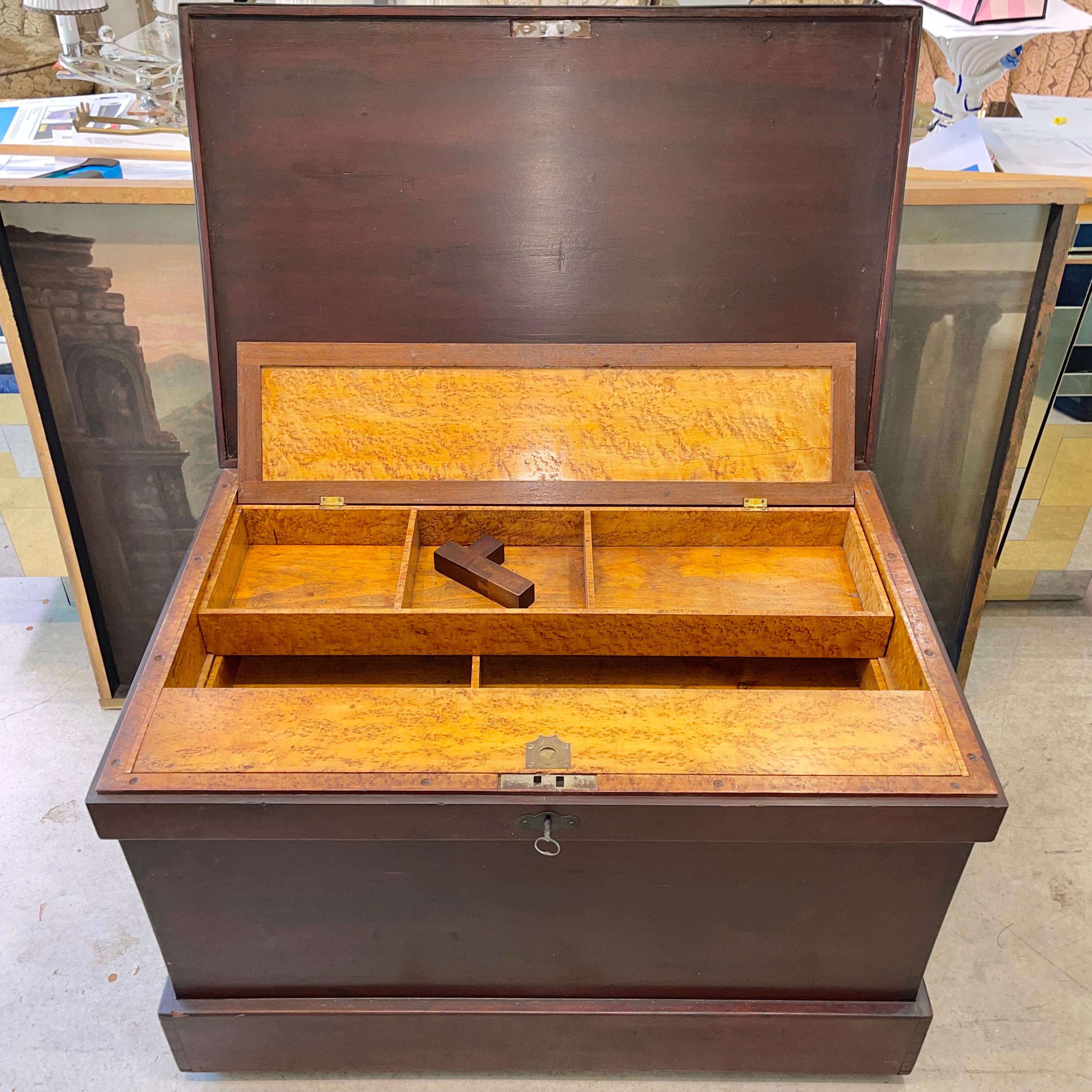 Finely crafted mid-Victorian carpenters tool chest, dovetailed construction, mahogany stained pine, forged steel banding around lidded top which when unlocked opens to reveal a fitted interior of birds eye maple with walnut trim. Two tills of