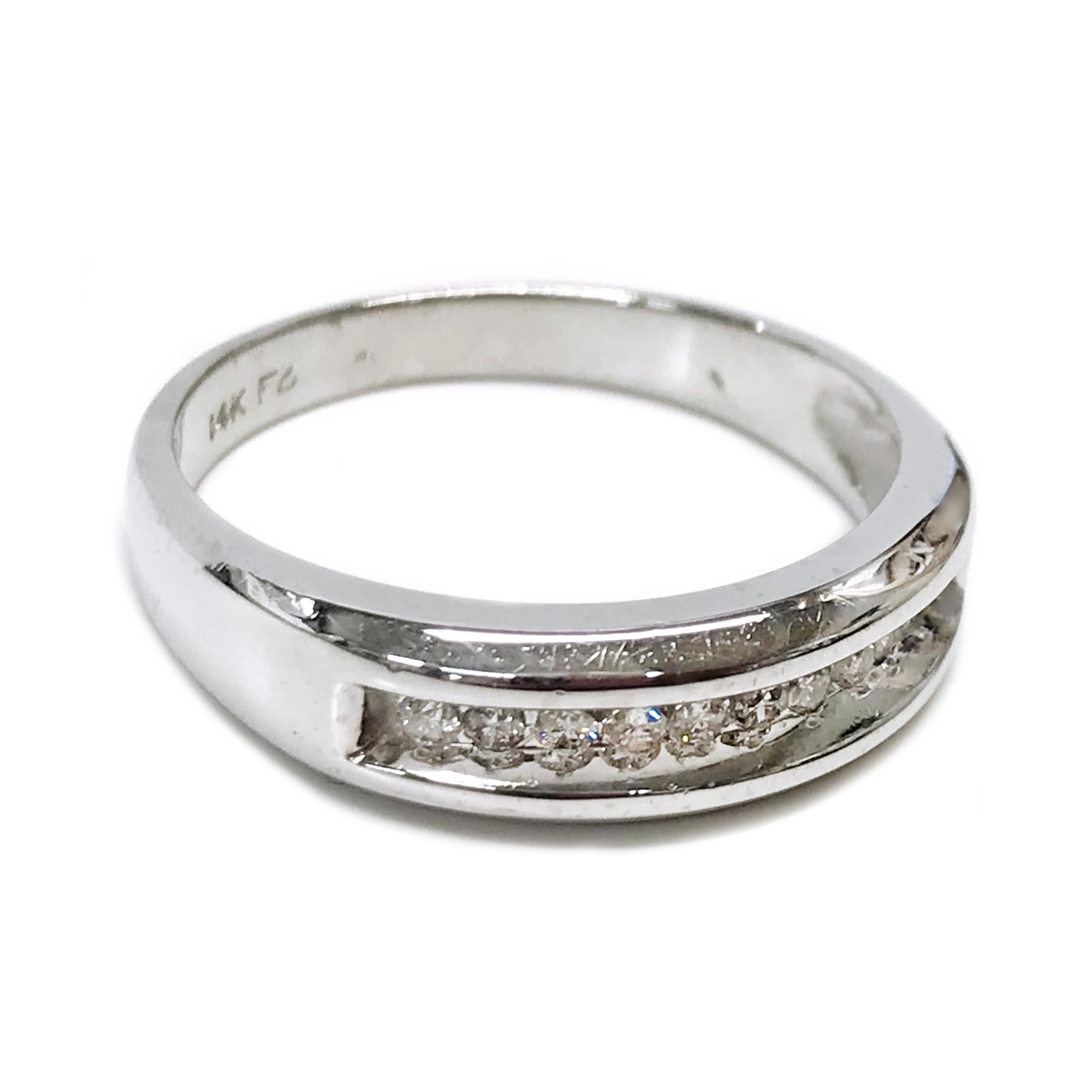 Gentleman’s 14 Karat White Gold Channel-Set Diamond Ring. The ring has a smooth shiny finish with eleven 2mm round diamonds channel-set with a total weight of 0.33ctw. Stamped on the inside of the band are 14K and the FG maker's mark. The ring size