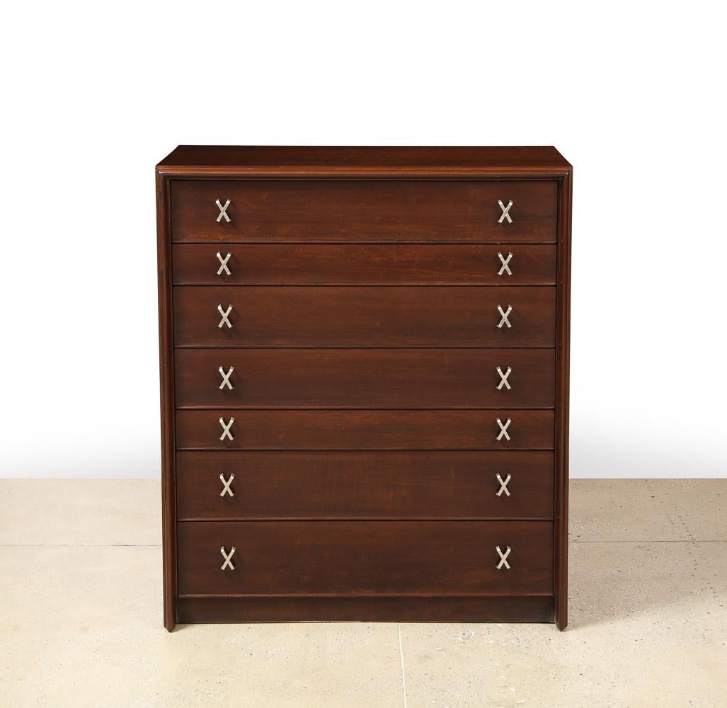 Seven-drawer chest of dark stained wood with brass x-pulls and raised detailing. Simple, elegant form with lots of storage.