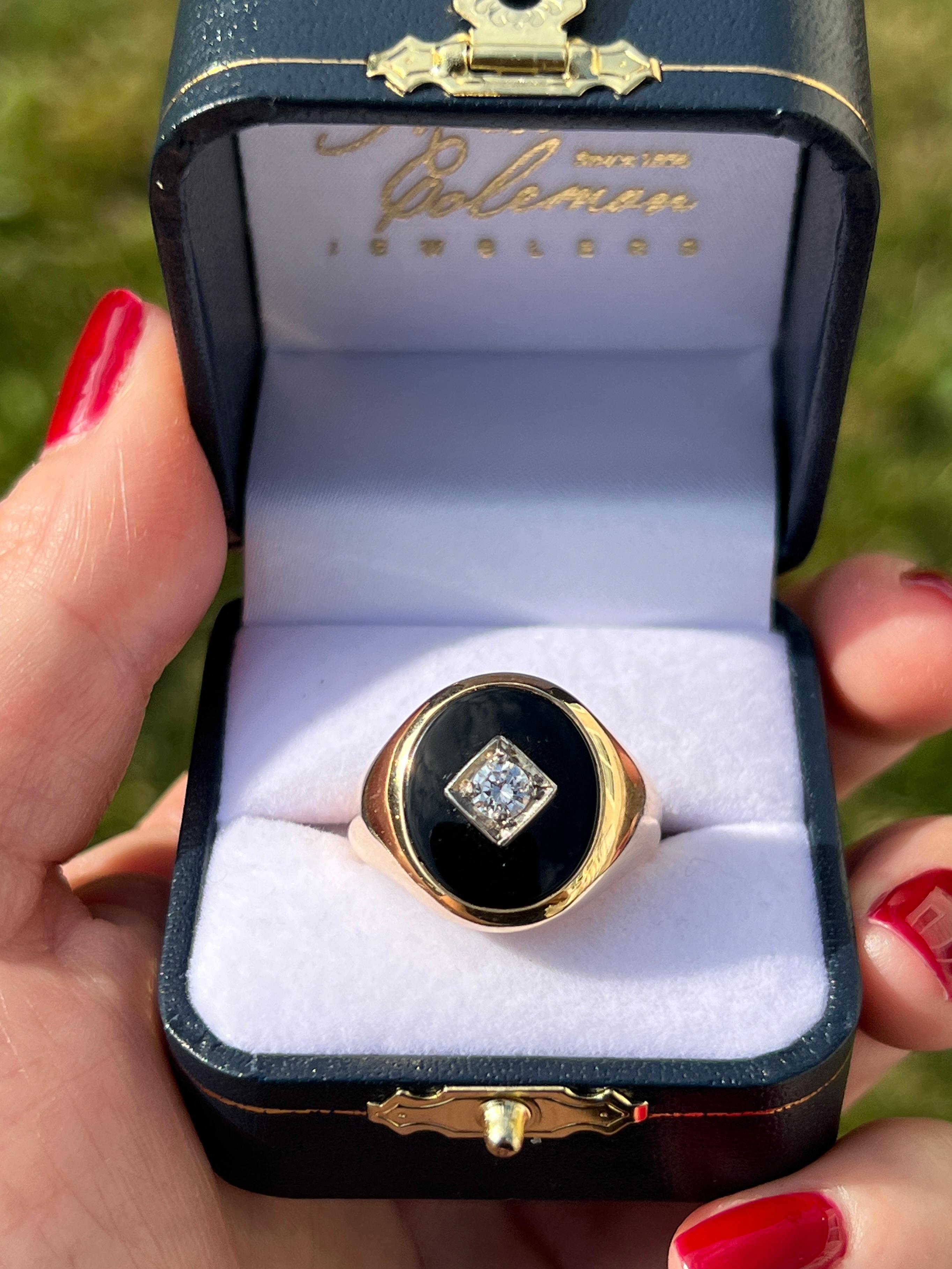 This distinguished gentleman's ring is crafted in 14 karat yellow gold, featuring a bold 16x14mm oval onyx at its center. A 0.25-carat diamond is elegantly set in a 14 karat white gold square mounting, adding a refined contrast. With its clean lines