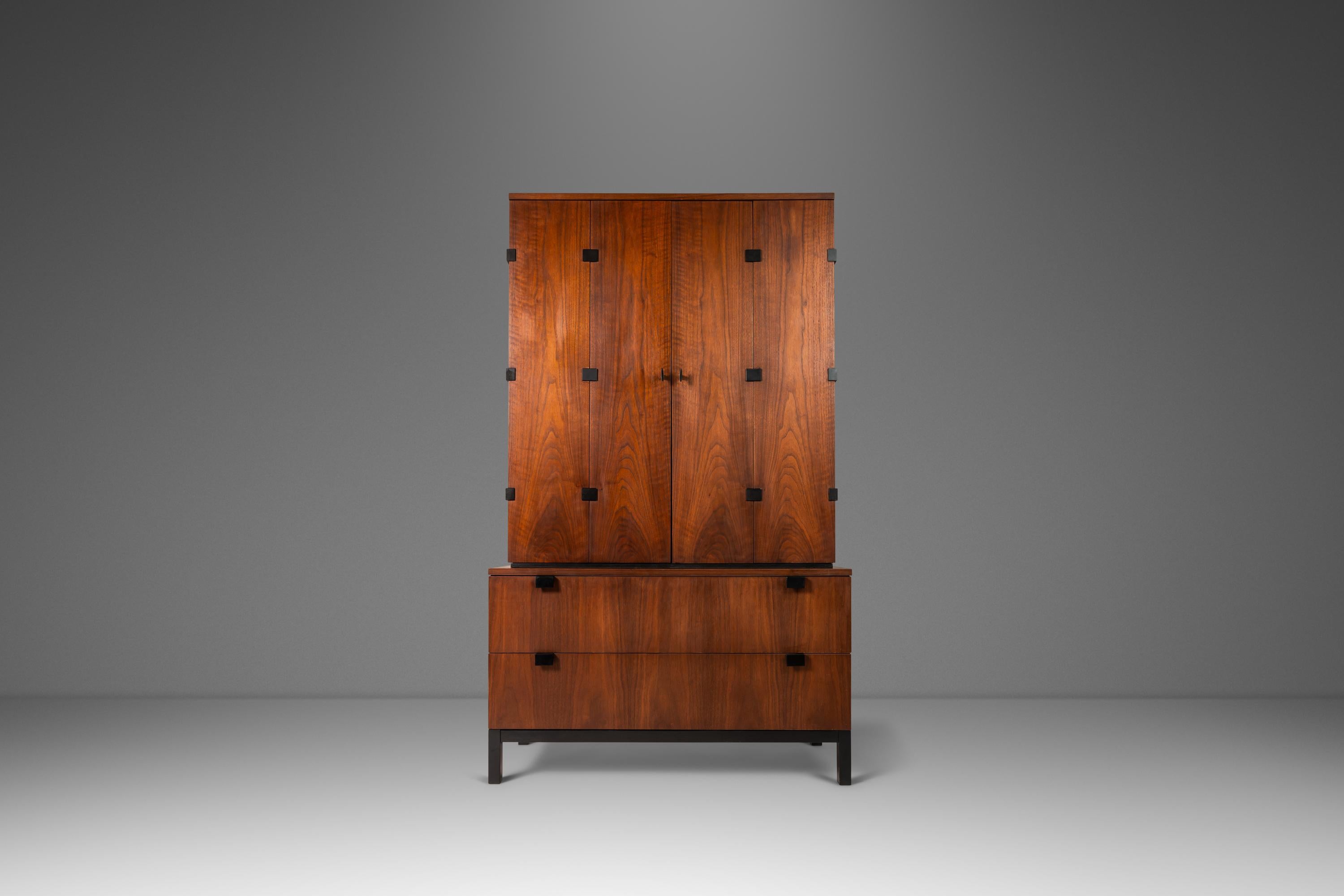 As rare as it is architecturally alluring this extraordinary tall-boy dresser, designed by the prolific Milo Baughman for the Directional Furniture Co., is a true Mid-Century Modern gem. Constructed from a mix of solid and veneered black walnut with