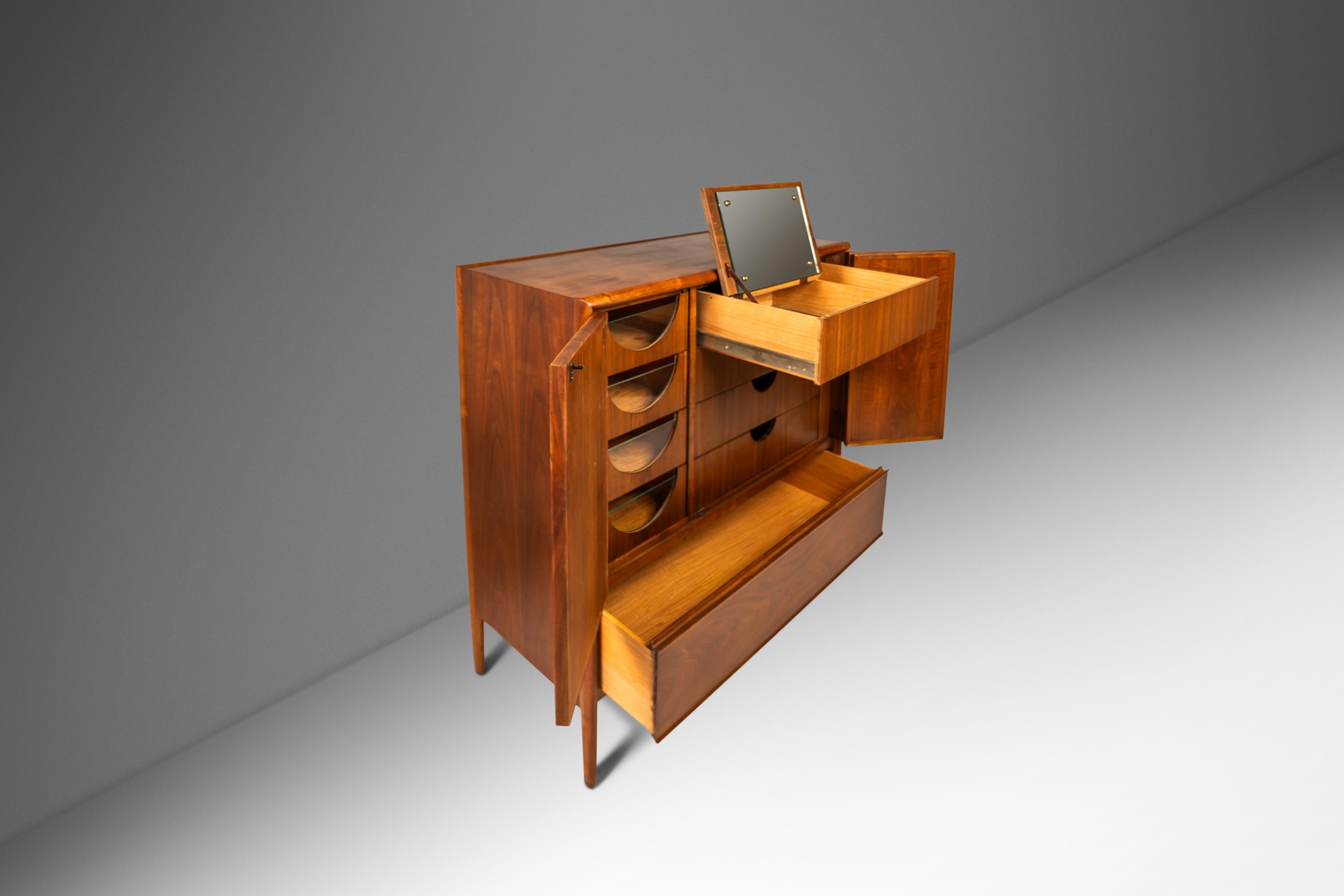 Discover the elegance of mid-century design with our rare Drexel Parallel Gentleman's Dresser. This limited-production piece, crafted in the 1960s, is a highly collectible item, perfect for enthusiasts and collectors. Made from high-quality walnut,