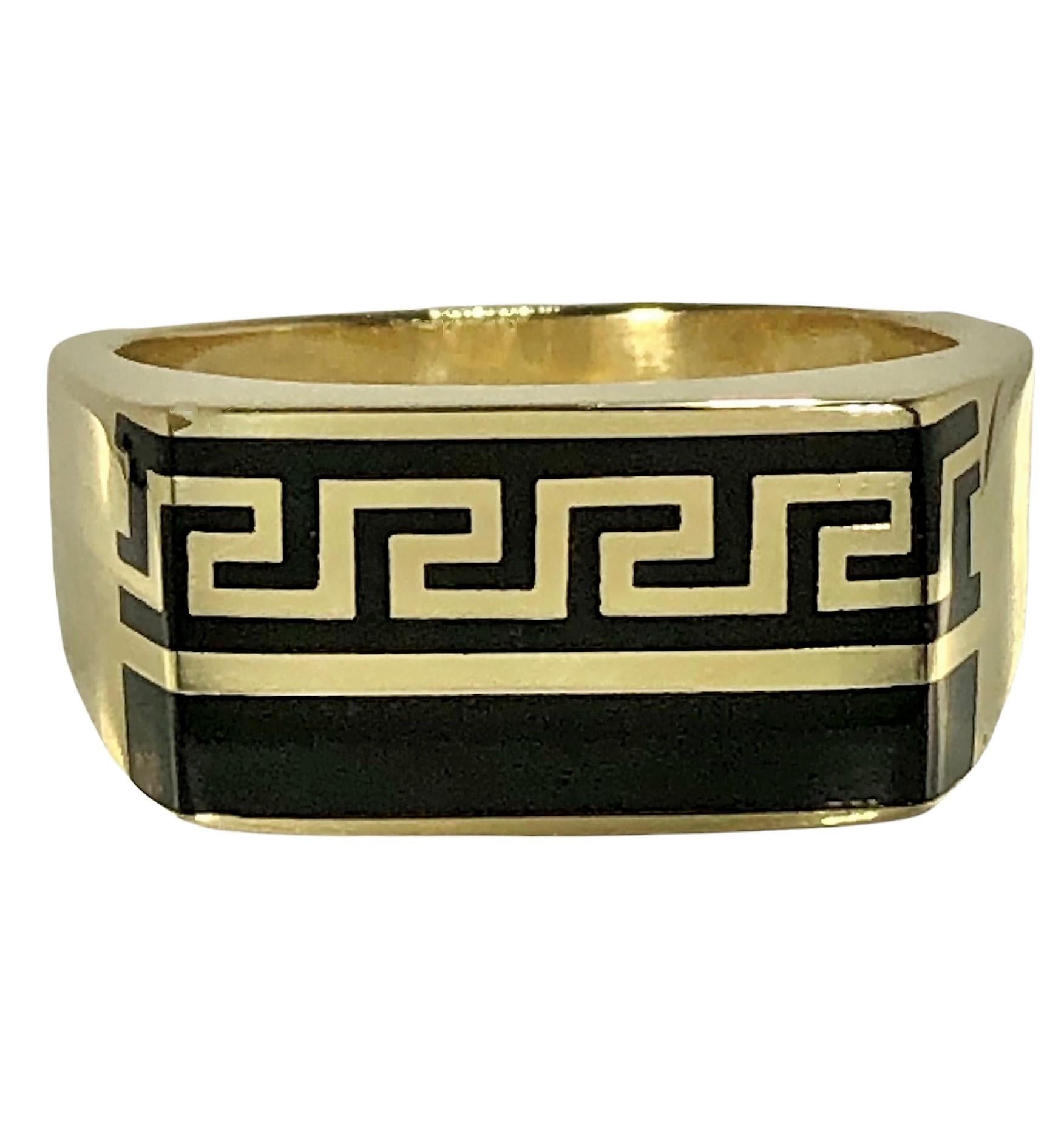 This sharp and tailored 14k yellow gold gents ring with a black enamel Greek Key motif is a true classic. The design area measures 13/16 inches by 7/16 inches and can be worn in two positions, with the Greek key motif on the top or on the bottom. 