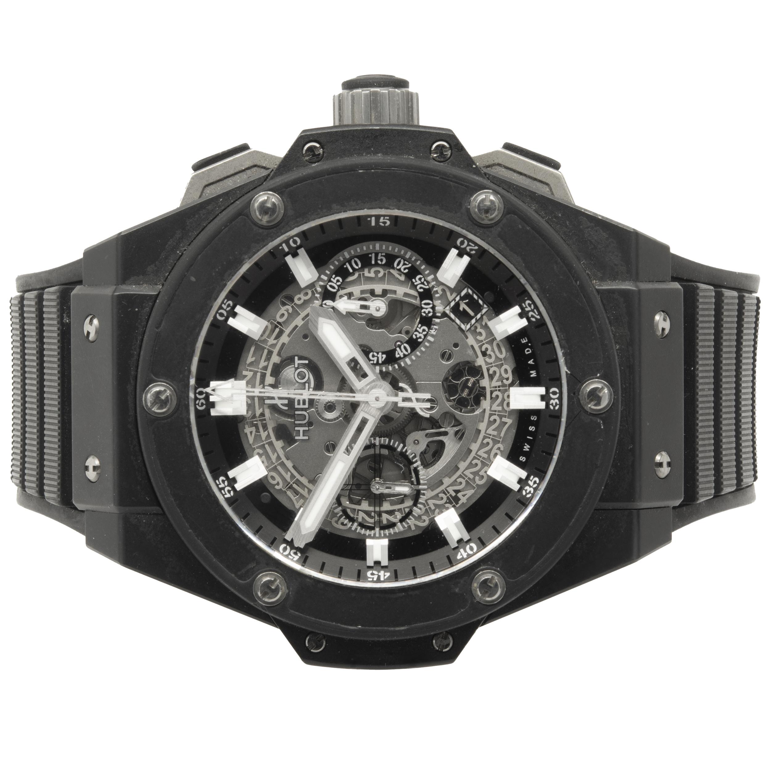 Movement:  Swiss, automatic, HUB1240
Function: hours, minutes, sweep seconds, chrono, date at 4:30
Case: 48mm black ceramic case and bezel, water resistant to 100 meters
Band: black rubber Hublot strap, black ceramic PVD/titanium deployment clasp,