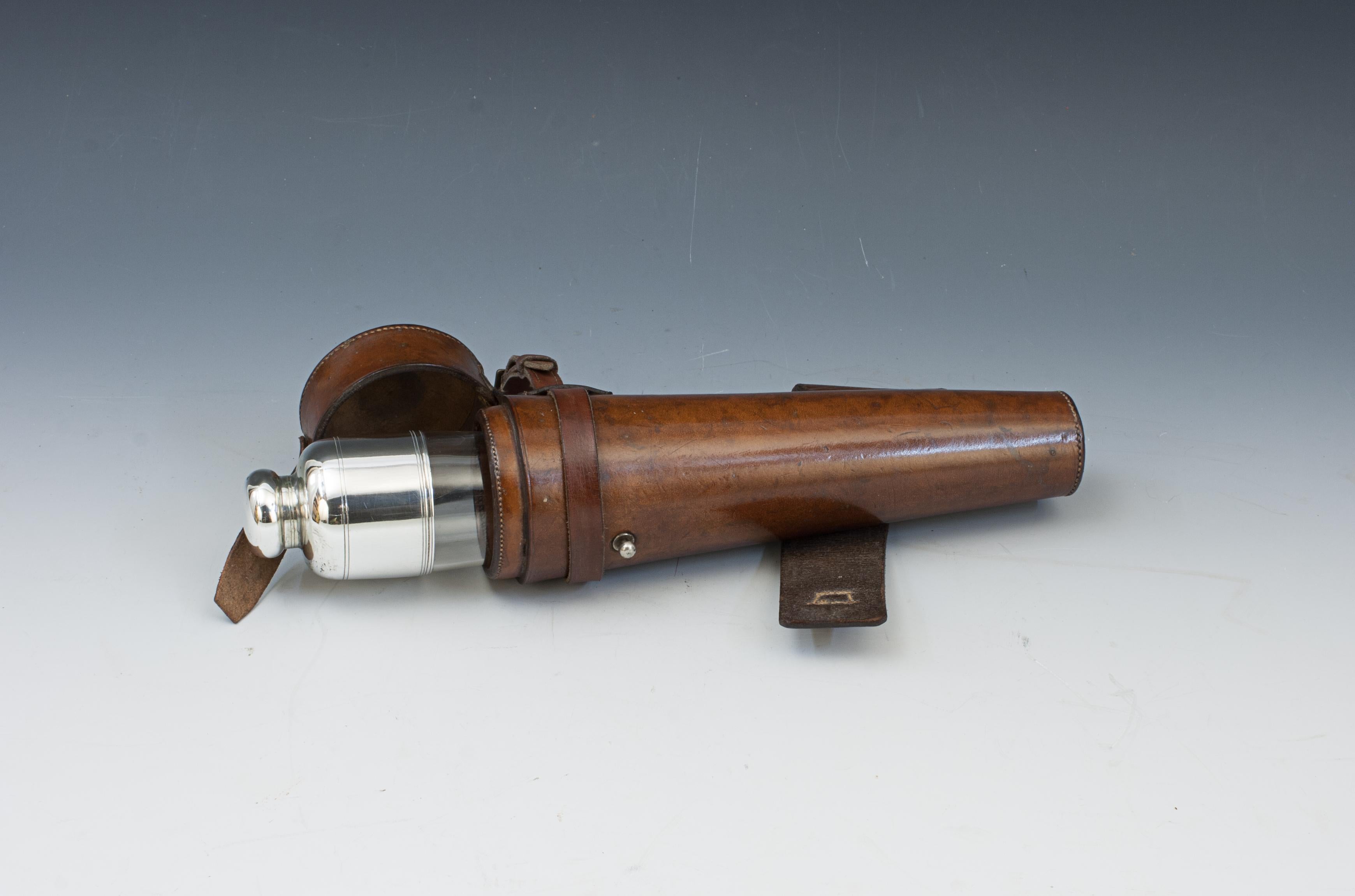 Vintage Conical Glass Hunting Saddle Flask.
A beautiful unusual hunting flask, conical shape with plated top and bayonet fitting, contained in leather saddle case. The saddle flask's leather holster has straps so that it can be attached to the