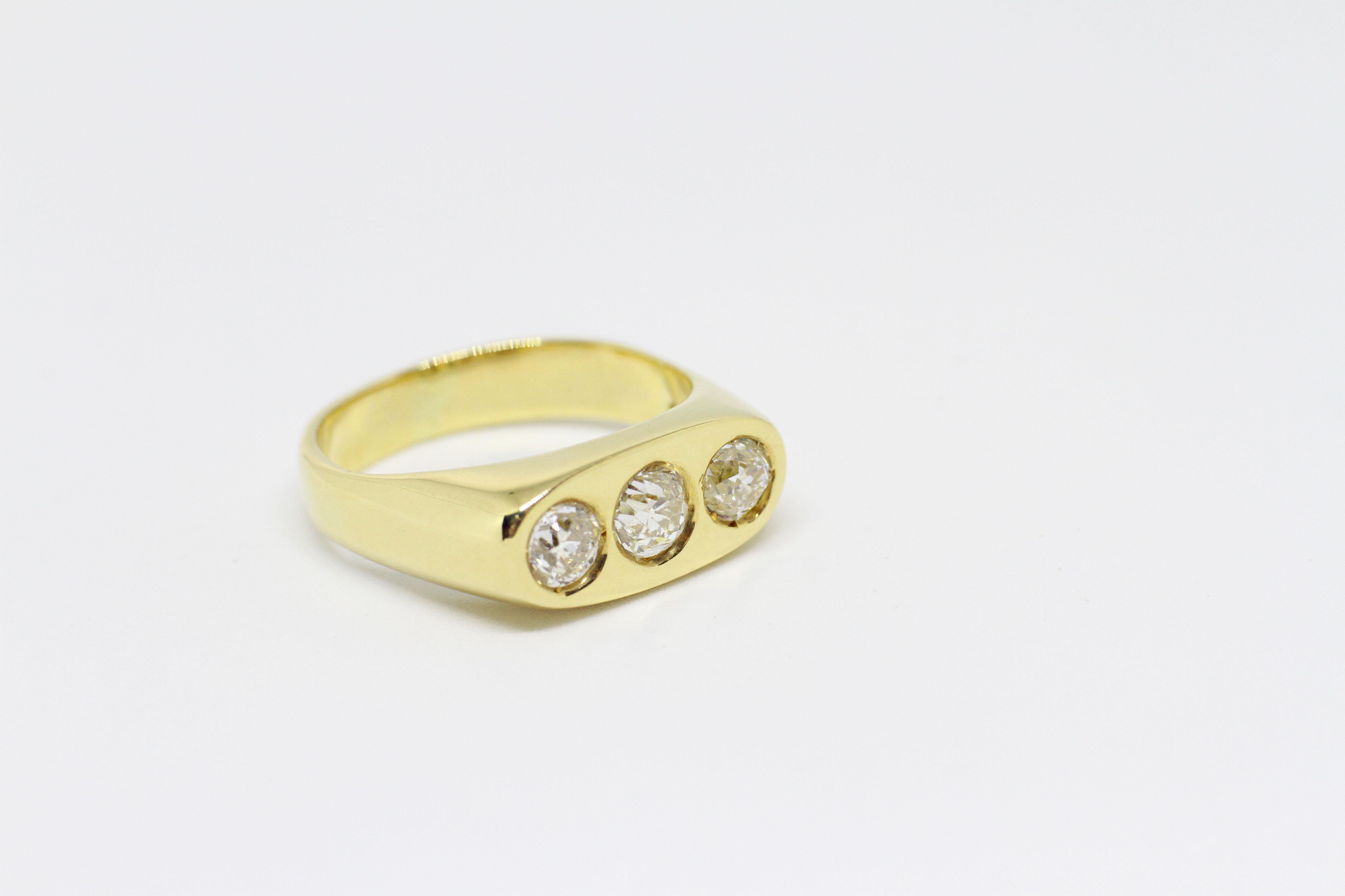 Yellow gold gents solid 'Gypsy' ring set with three old cut diamonds in rub-over settings weighing a total of 1.59 carats. Flat plate top moving to a solid court shaped shank of 4.5mm-5mm. Tested 18 carat yellow gold. English. Stones set later in