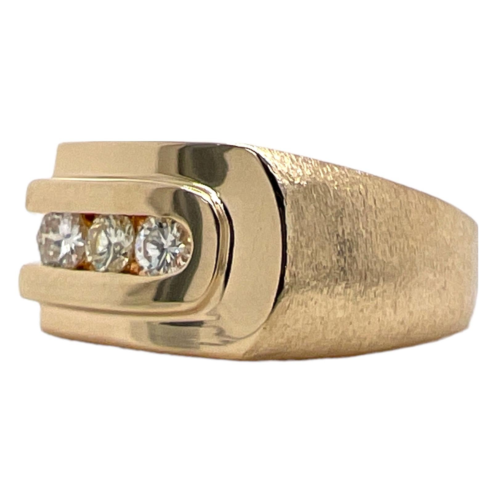 Gents three diamond band ring fashioned in 14 karat satin finish and high polish yellow gold. The ring features 3 round brilliant cut diamonds weighing approximately .45 CTW and graded J color and VS clarity. The band measures 3.5- 10mm, and is