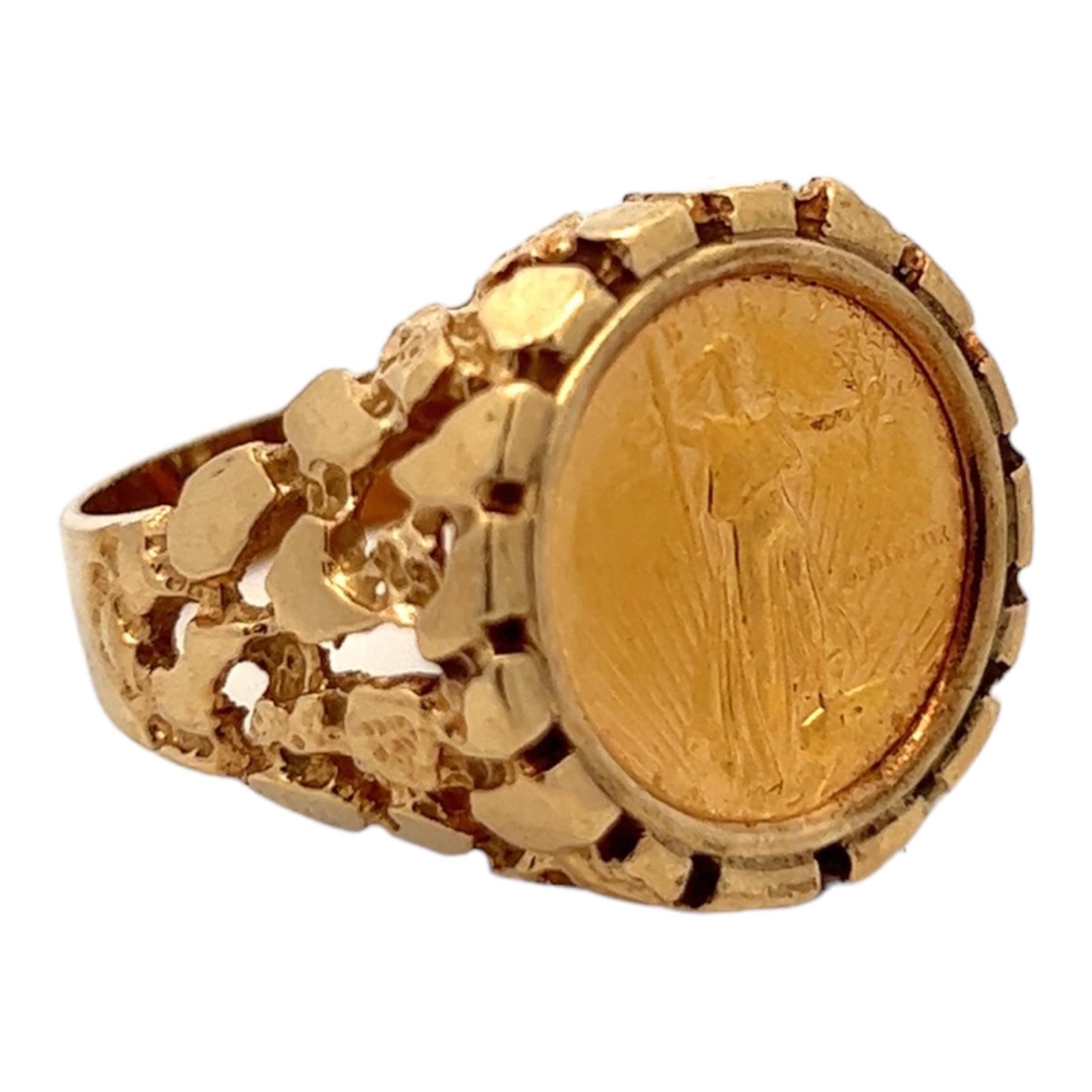Gents nugget coin ring crafted in 14 karat yellow gold. The ring features a 1/10 oz US gold Liberty coin set in a gold nugget ring. The ring is currently size 11 (can be sized), and graduates from 5-20mm in width. 