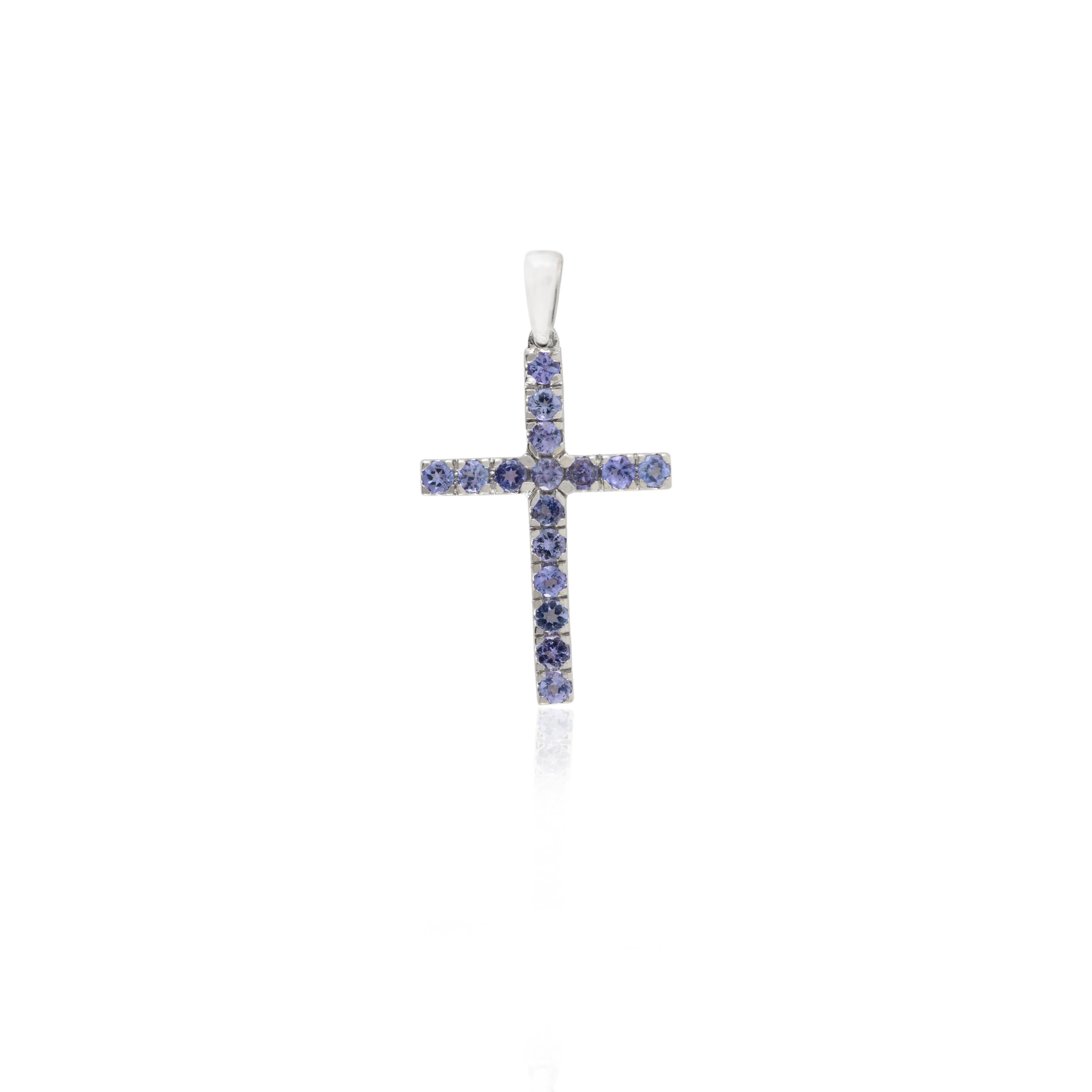 Genuine Tanzanite Cross Pendant in 18K Gold studded with round cut tanzanite. This stunning piece of jewelry instantly elevates a casual look or dressy outfit. 
Tanzanite brings energy, calmness and happiness into life. 
Designed with round cut