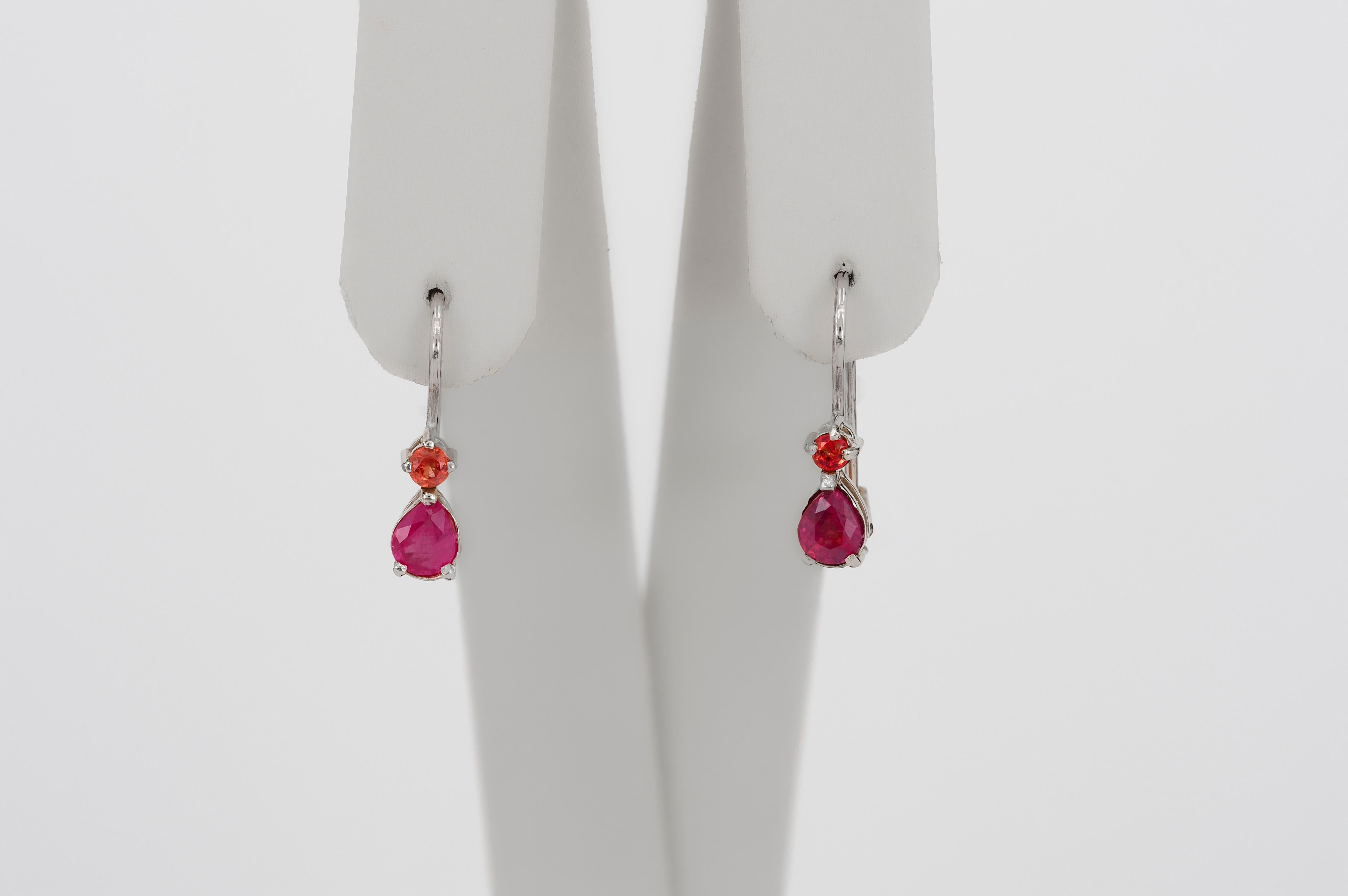 Genuine 1 ct rubies and sapphires earrings. 
14k solid gold earrings. Pear ruby earrings. Red gemstone earrings. Small tiny earrings.

Weight: 1.63 g.
Size: 17.6x5mm .
Metal: 14k gold.

Central stones: Rubies
2 pieces, pear cut
Weight: 0.84 ct (2 x