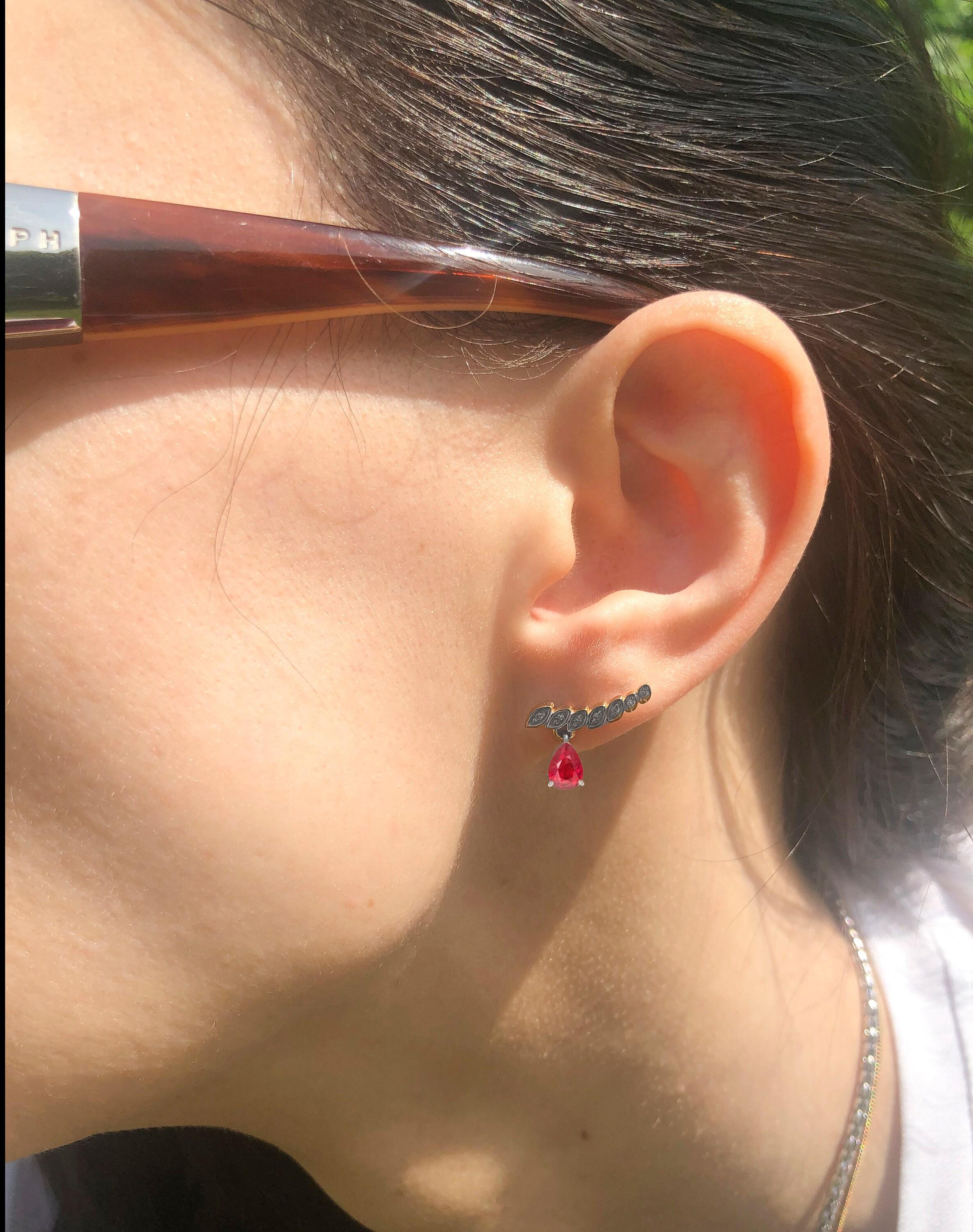 Genuine 1.5 ct rubies and diamonds earrings studs in 925 silver.

Metal: 925 silver
Size: 15.5 x 10 mm
Weight: 2.4 gr.

Central stones: Natural rubies - 2 pieces
Cut: Pear
Weight: aprx 1.5 ct. total.
Color: red
Clarity: Transparent with