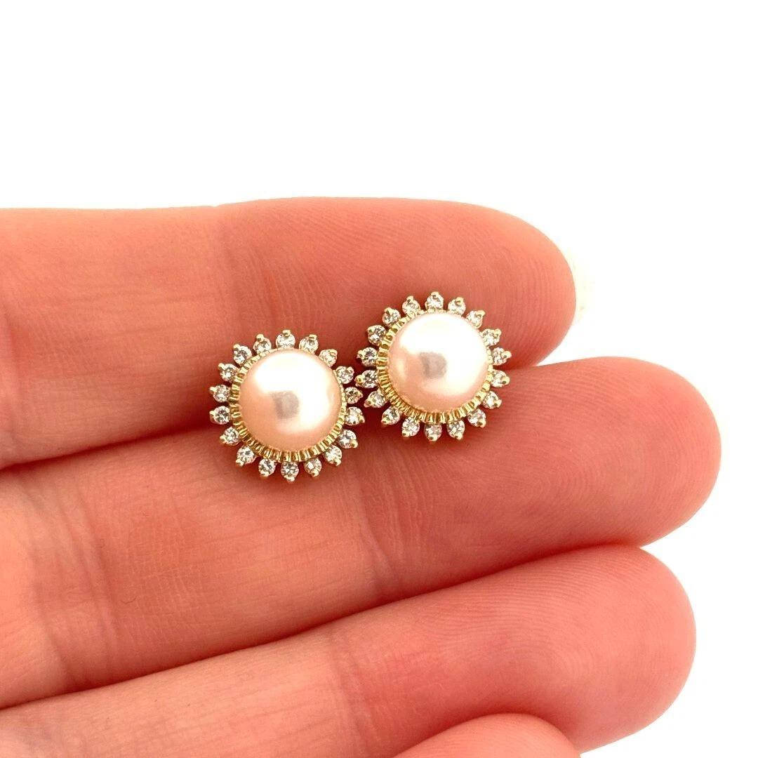 Elegant and timeless, these vintage-inspired halo earrings feature two luminous 7mm genuine Akoya cultured pearls, each encircled by a glittering halo of natural round brilliant cut diamonds. Crafted in solid 14K yellow gold, the diamonds total