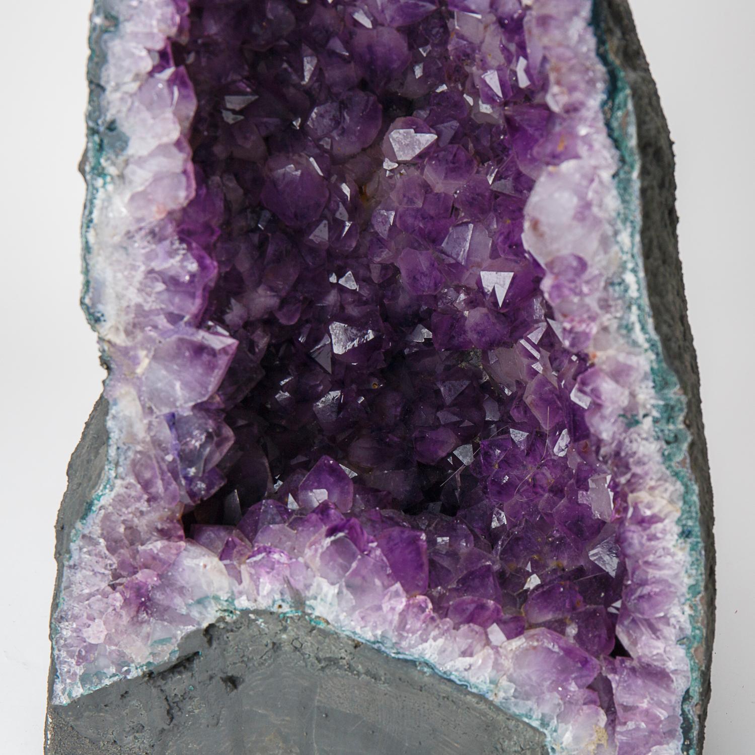 This Genuine Amethyst Cluster Geode from Brazil is a top quality natural formation of gem amethyst. The half geode cathedral decor features lustrous fully terminated crystals with highly reflective faces and a deep, transparent to translucent grape